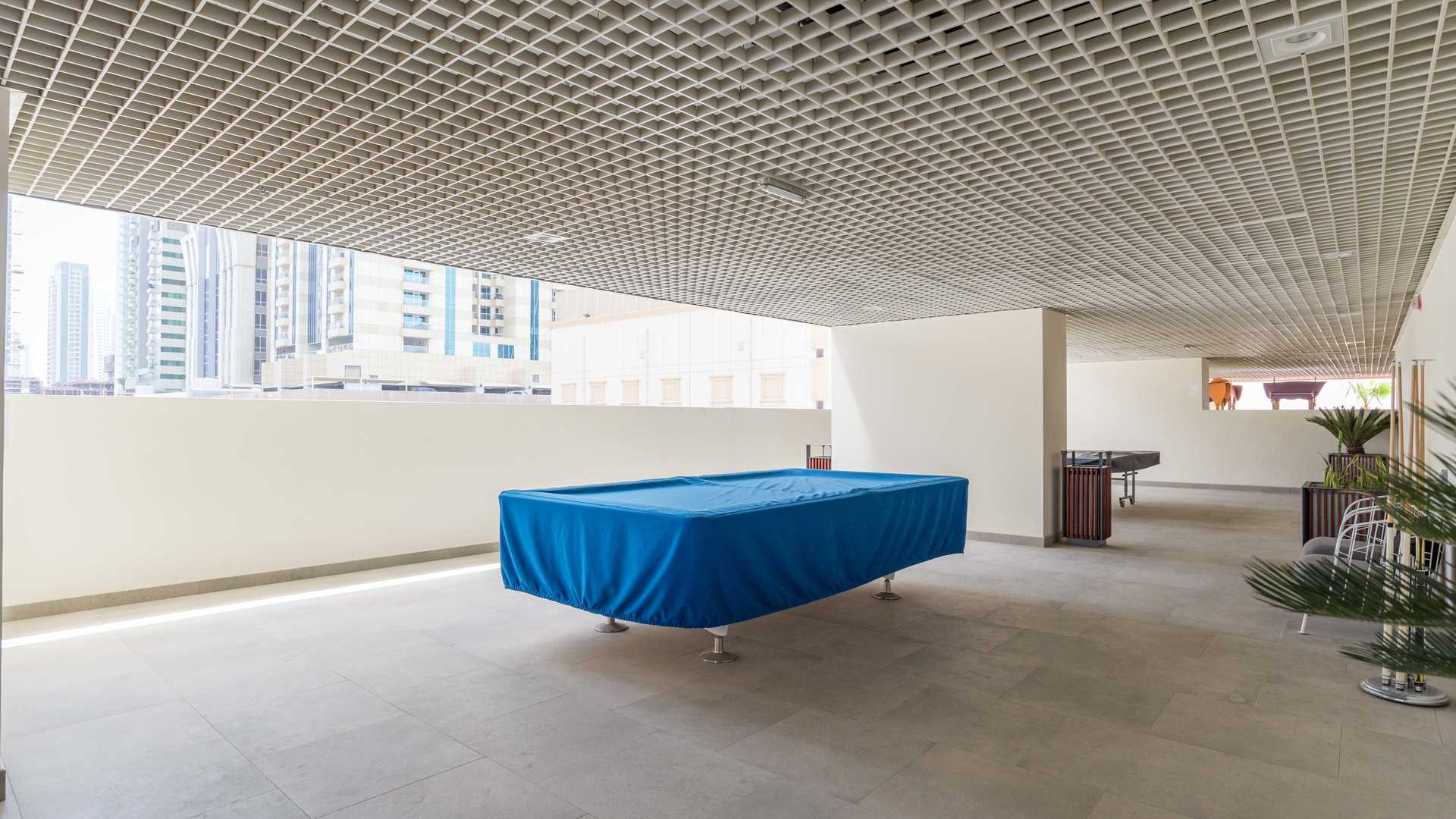 Modern lounge area in Marina Arcade Tower apartment, featuring stylish blue seating and decor