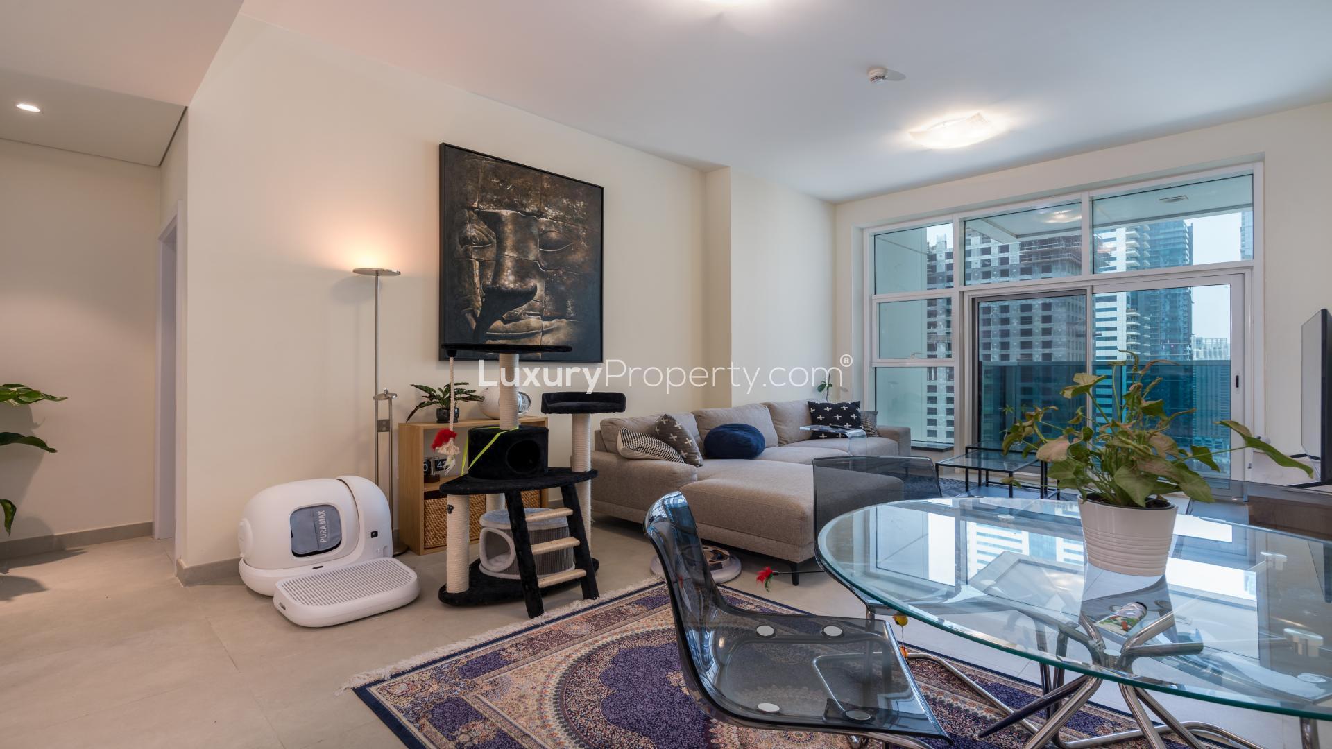 Contemporary living room in Dubai Marina apartment, featuring stylish decor and large windows