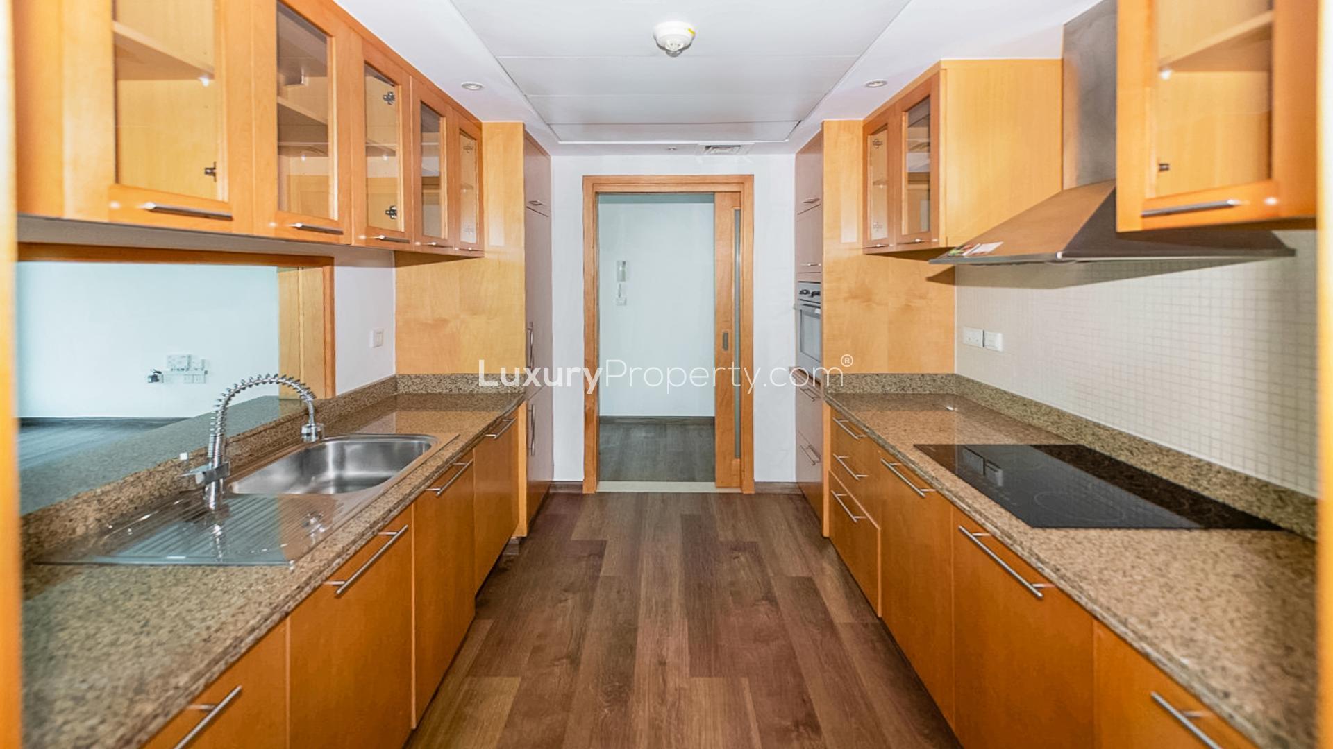 Empty apartment with marina view through large windows at Marina Promenade, Dubai Marina