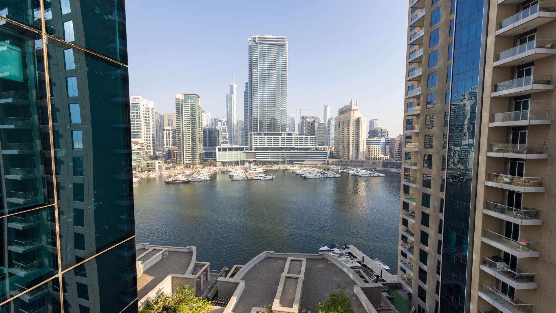 Modern apartment living room with large windows and marina views in Dubai Marina
