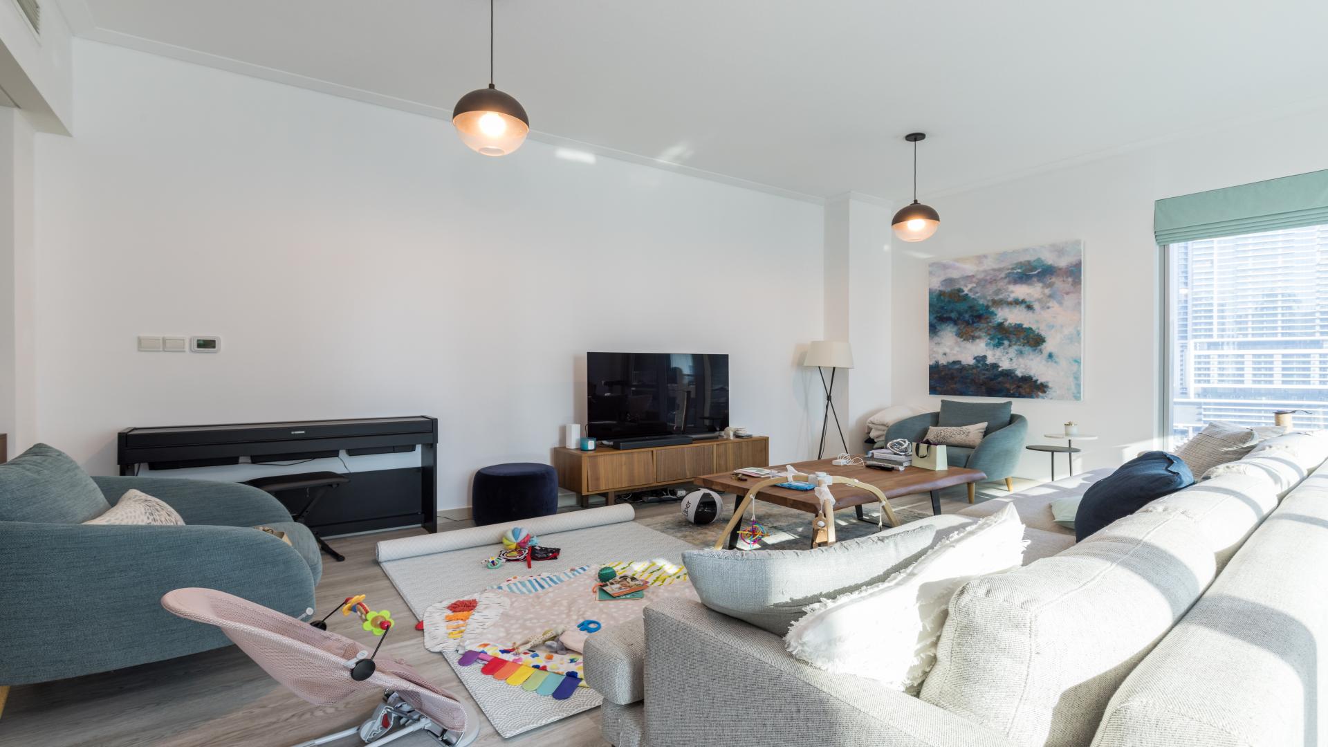 Modern Dubai Marina apartment living room with dining area and stunning views