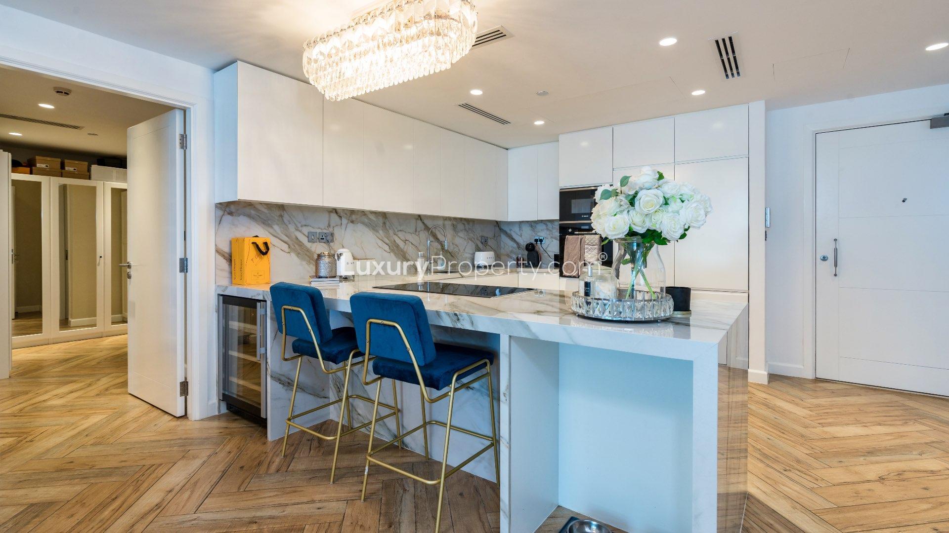 Modern living room in upgraded Palm Jumeirah apartment with city view through large windows