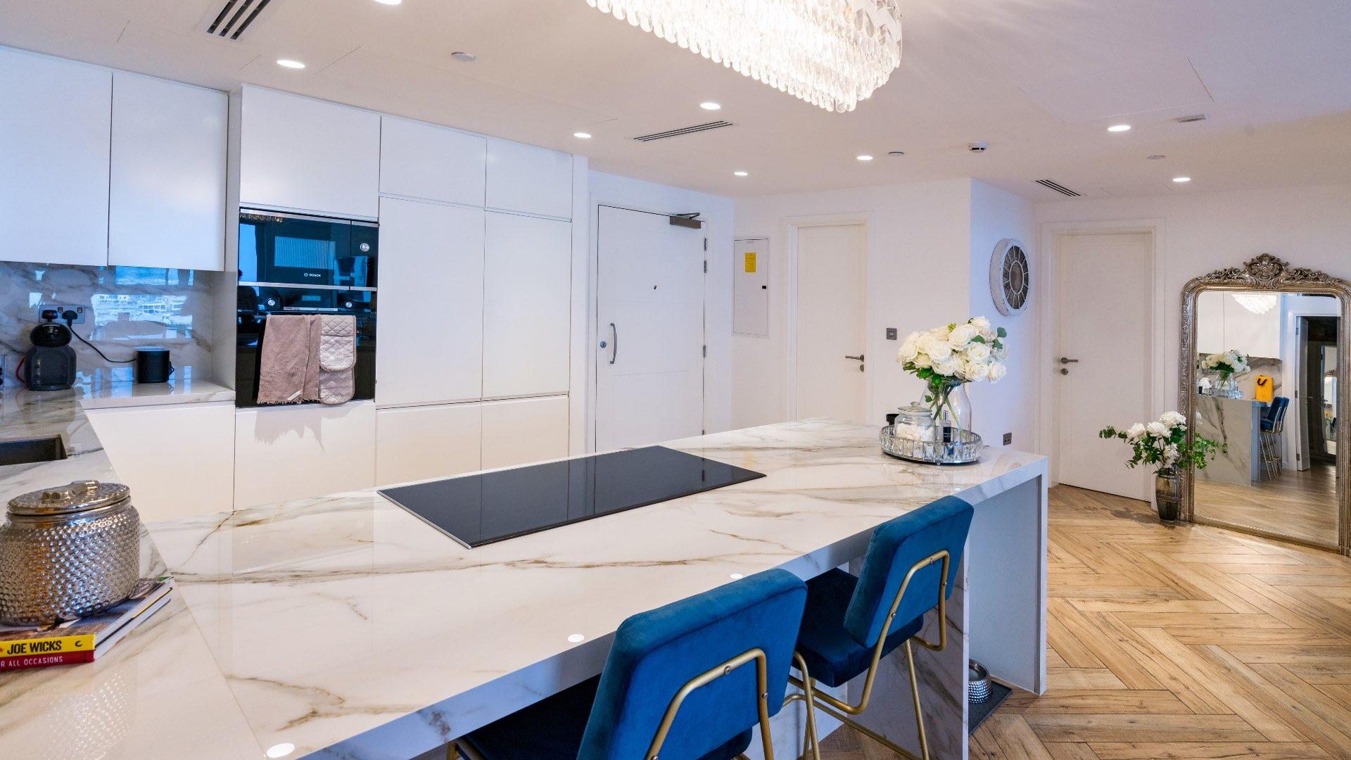Modern kitchen in fully upgraded Palm Jumeirah apartment, featuring marble countertops and elegant design