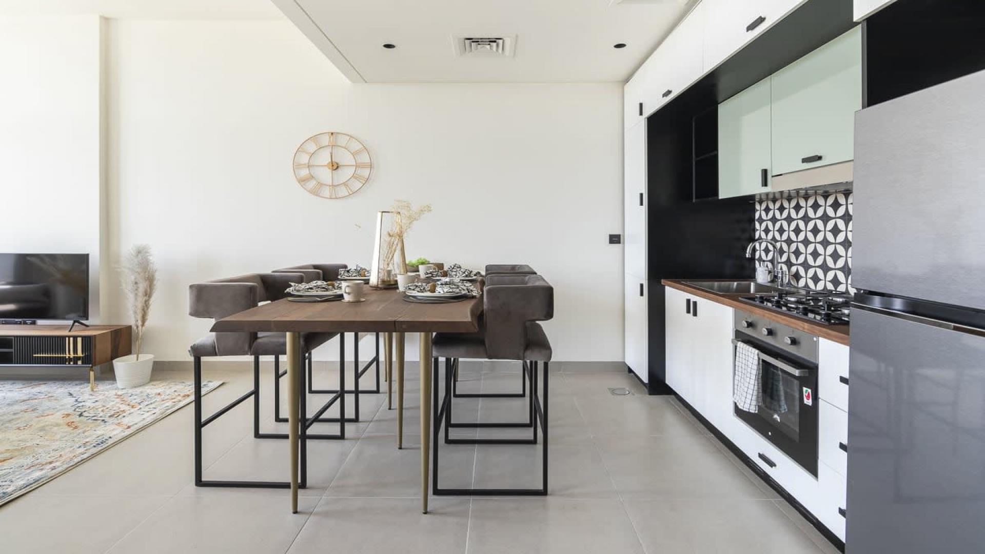 Furnished bedroom in Dubai Hills Estate apartment for sale, featuring modern decor and natural light