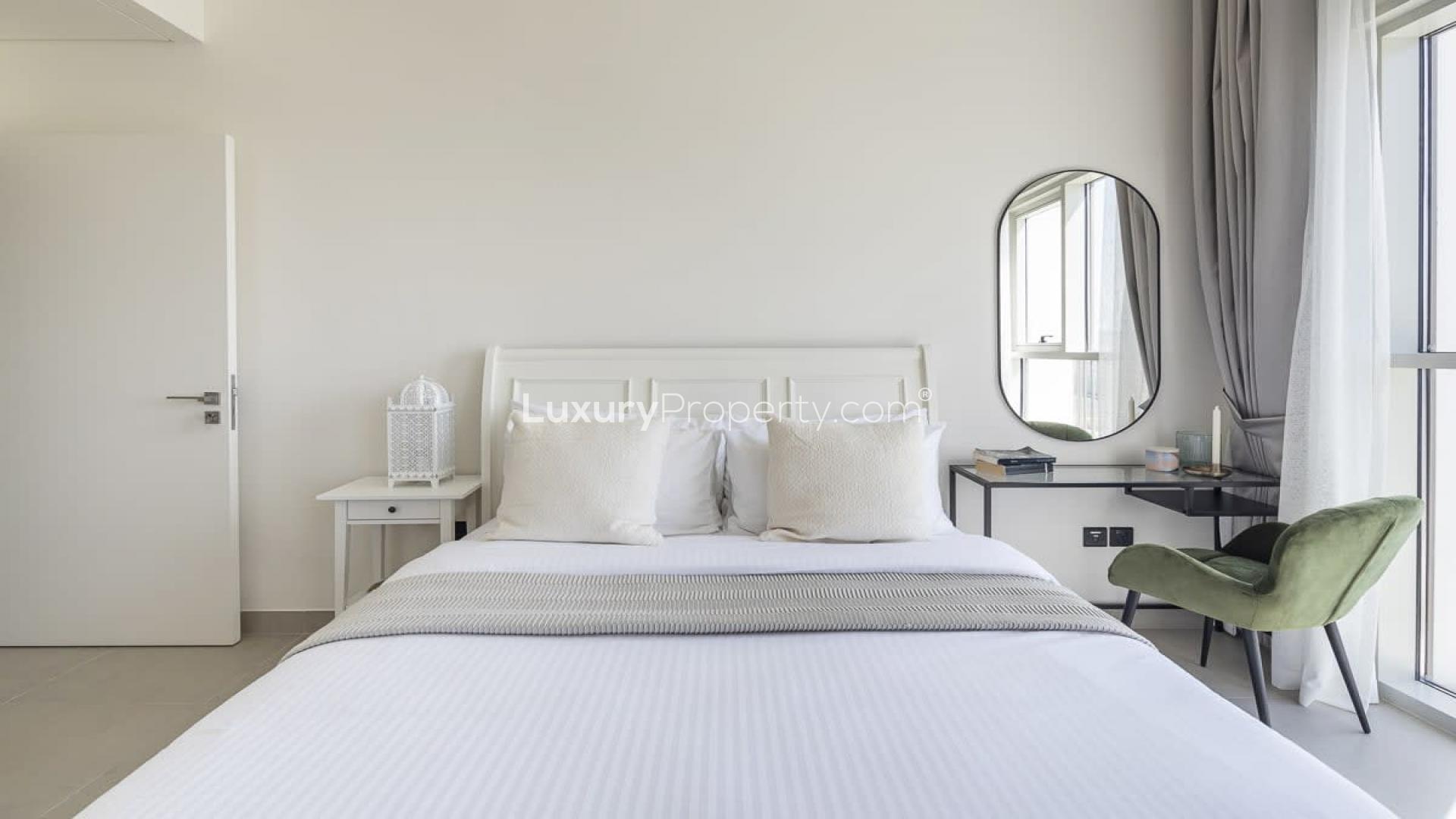 Furnished living room in Dubai Hills Estate apartment with balcony and mall view