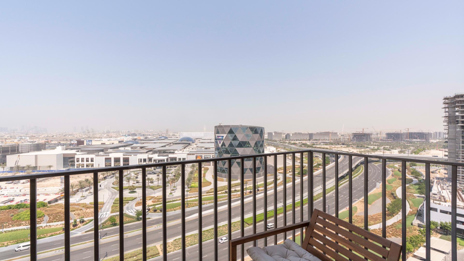 Modern living room in Dubai Hills Estate apartment with balcony and elegant decor