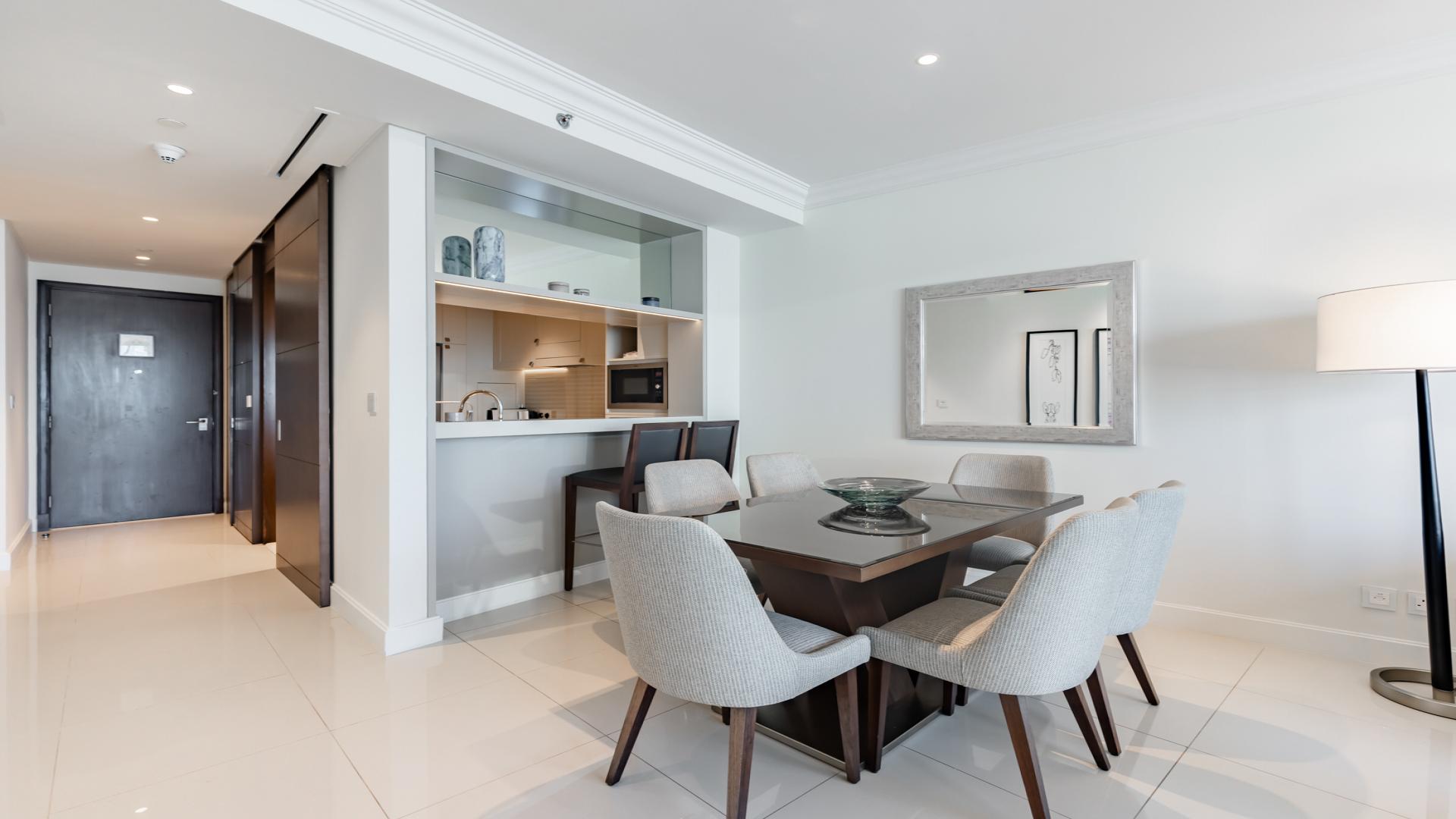 Modern living room in spacious Downtown Dubai apartment, featuring elegant decor and open layout