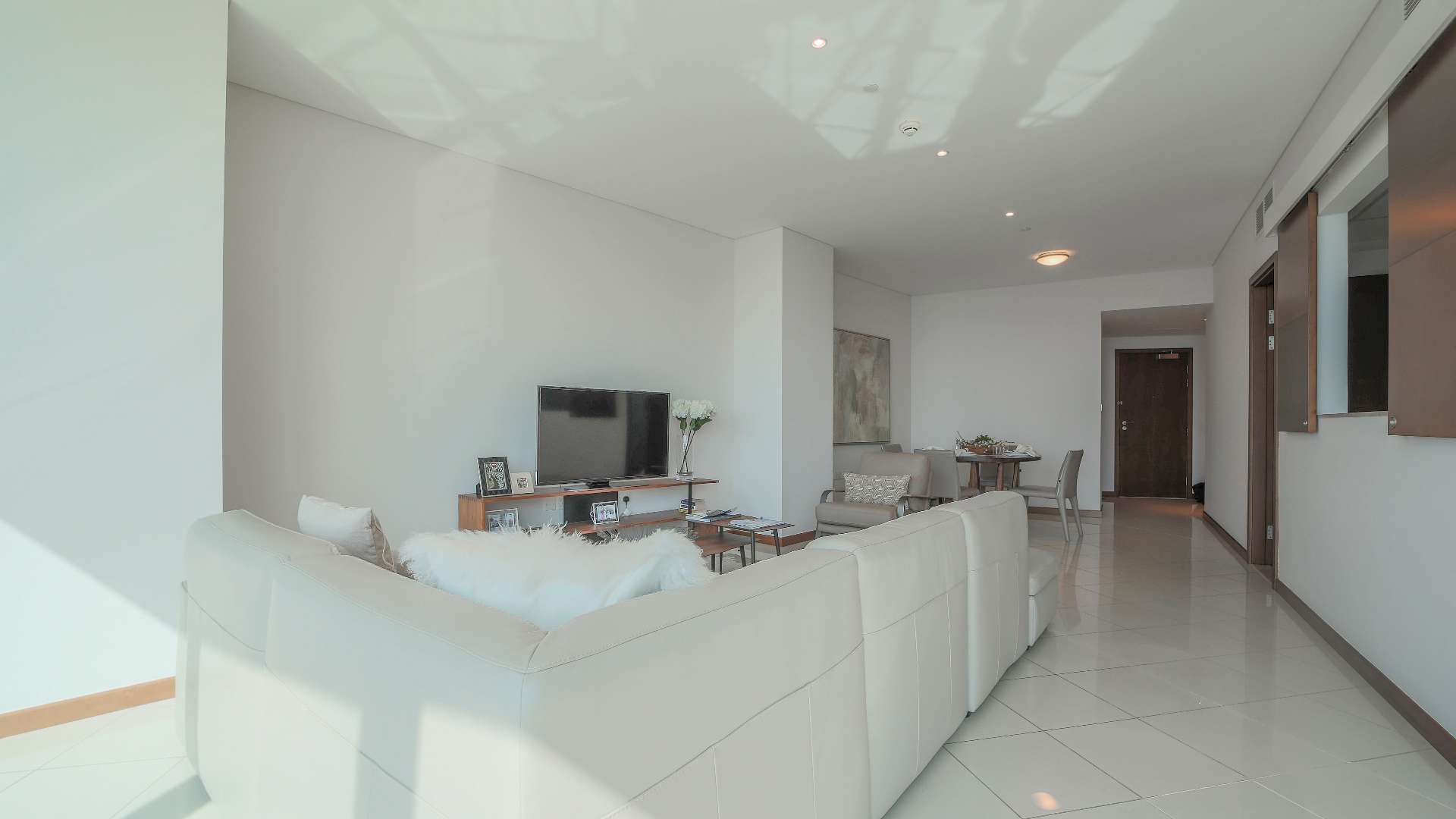 Modern living room and dining area in two-bedroom apartment, Festival City, Dubai