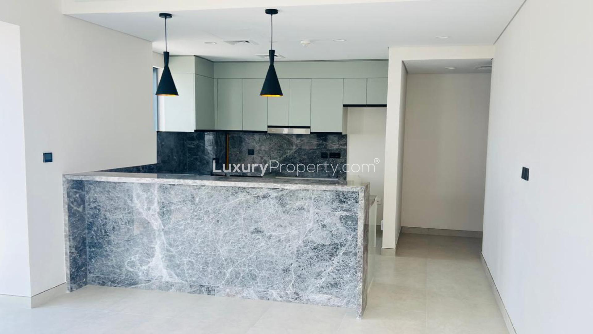 Hallway in 2-bedroom apartment at Golf Gate, DAMAC Hills, featuring modern wood finishes