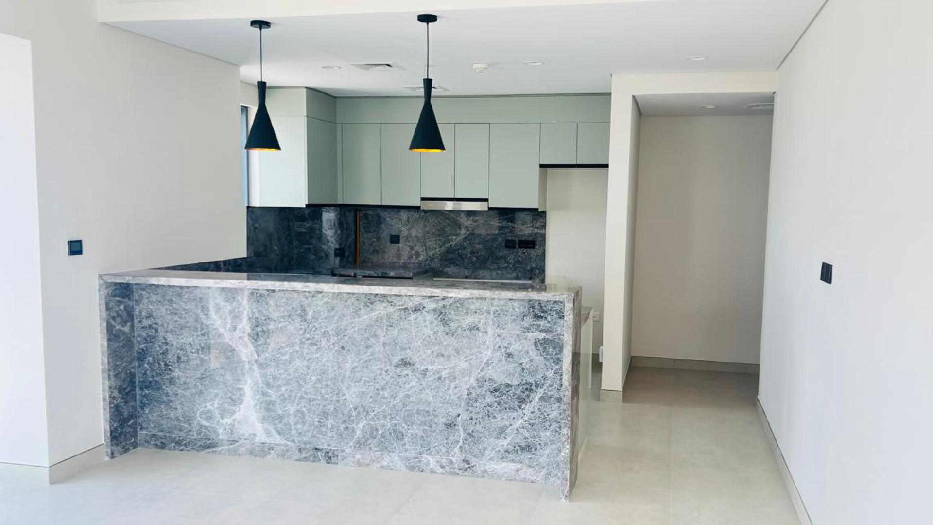 Hallway in 2-bedroom apartment at Golf Gate, DAMAC Hills, featuring modern wood finishes