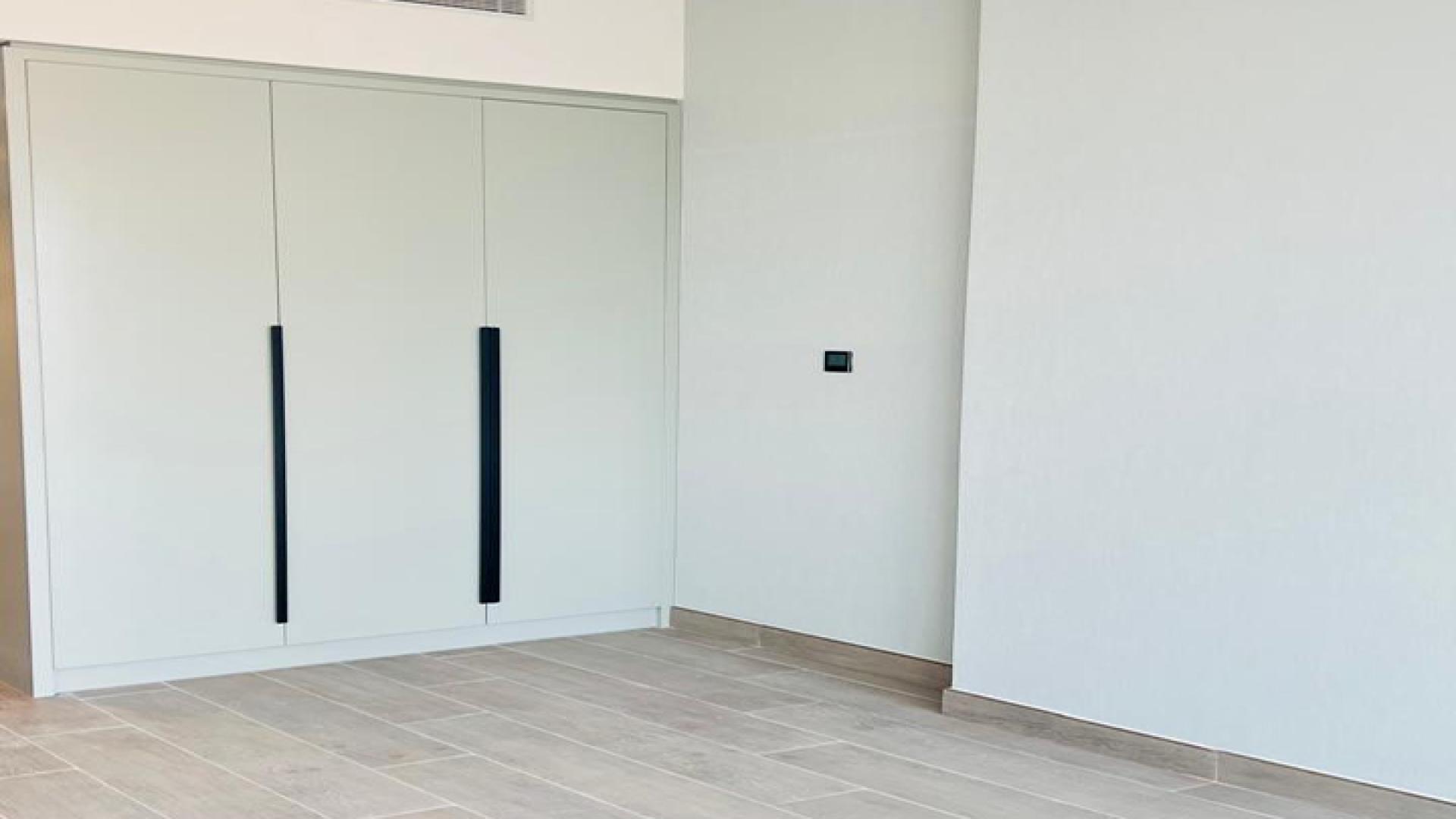 Modern kitchen in 2-bedroom apartment for sale at Golf Gate, DAMAC Hills