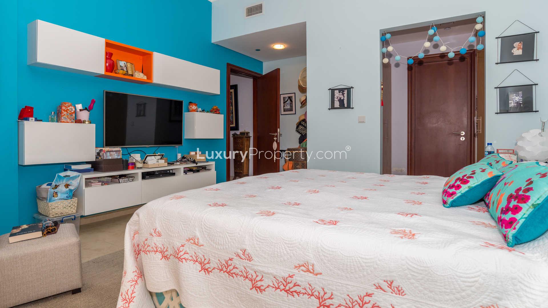 Chic bedroom with patterned headboard in Canal Residence, Dubai Sports City apartment for sale