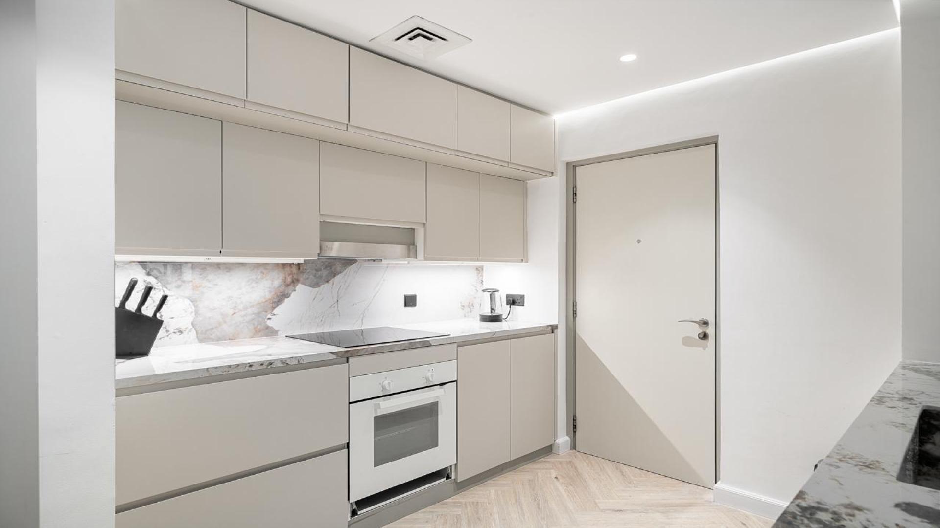 Modern bathroom in Jumeirah Beach Residence apartment, featuring sleek black fixtures and stone wall