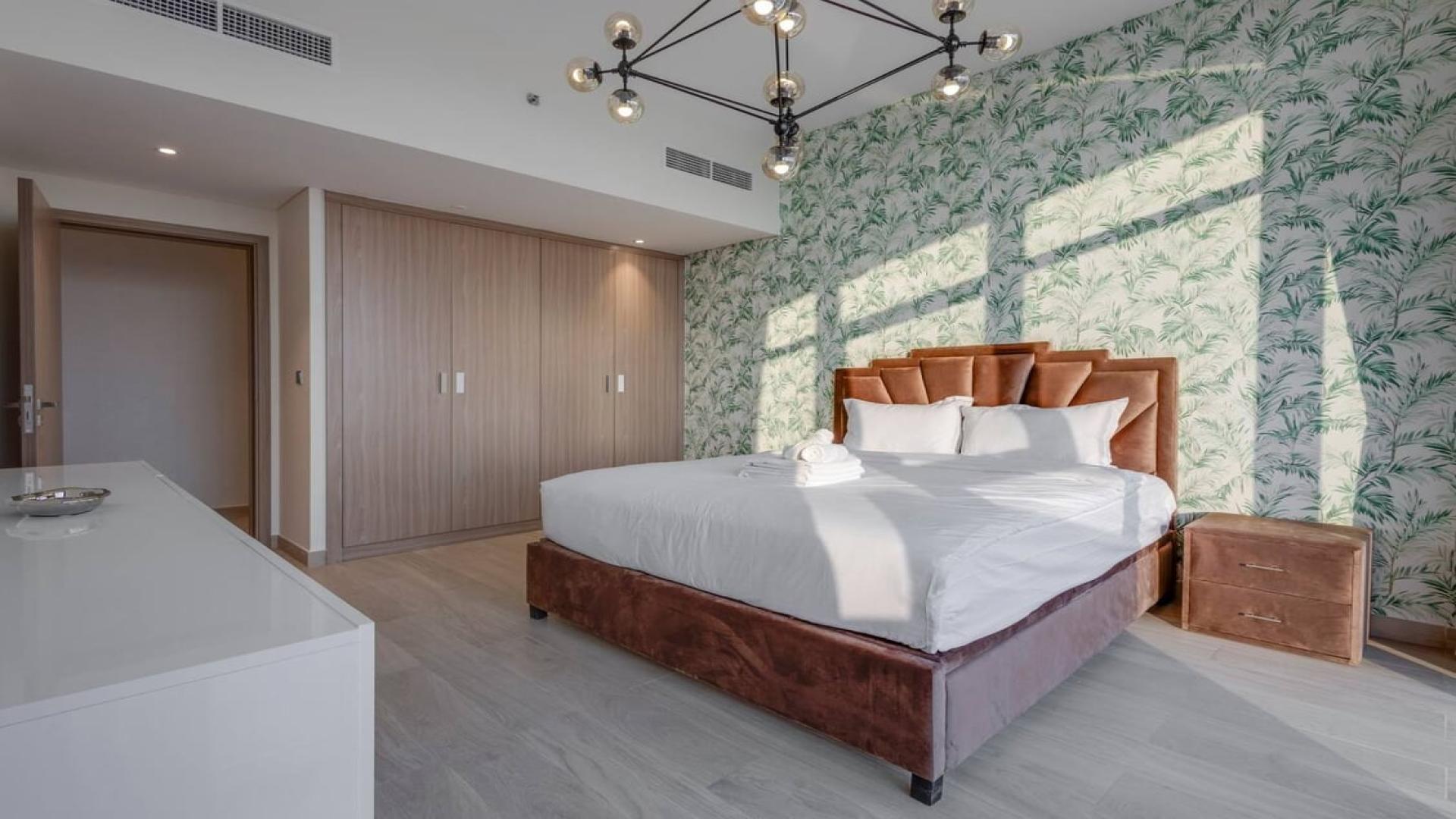 Stylish living room in 2-bedroom Meydan One apartment with modern decor and large windows