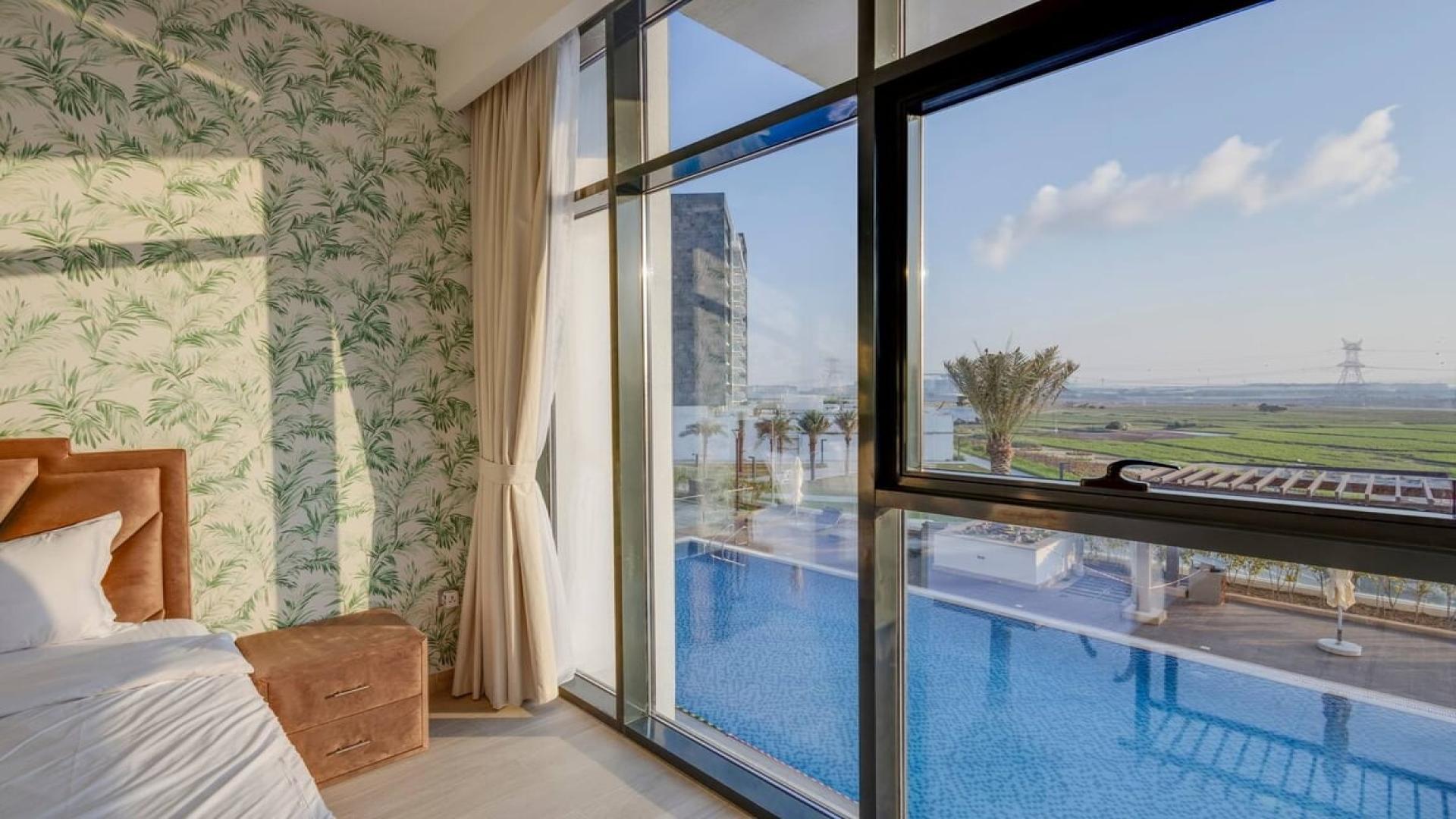 Modern living room in Meydan One apartment, featuring stylish furniture and large windows