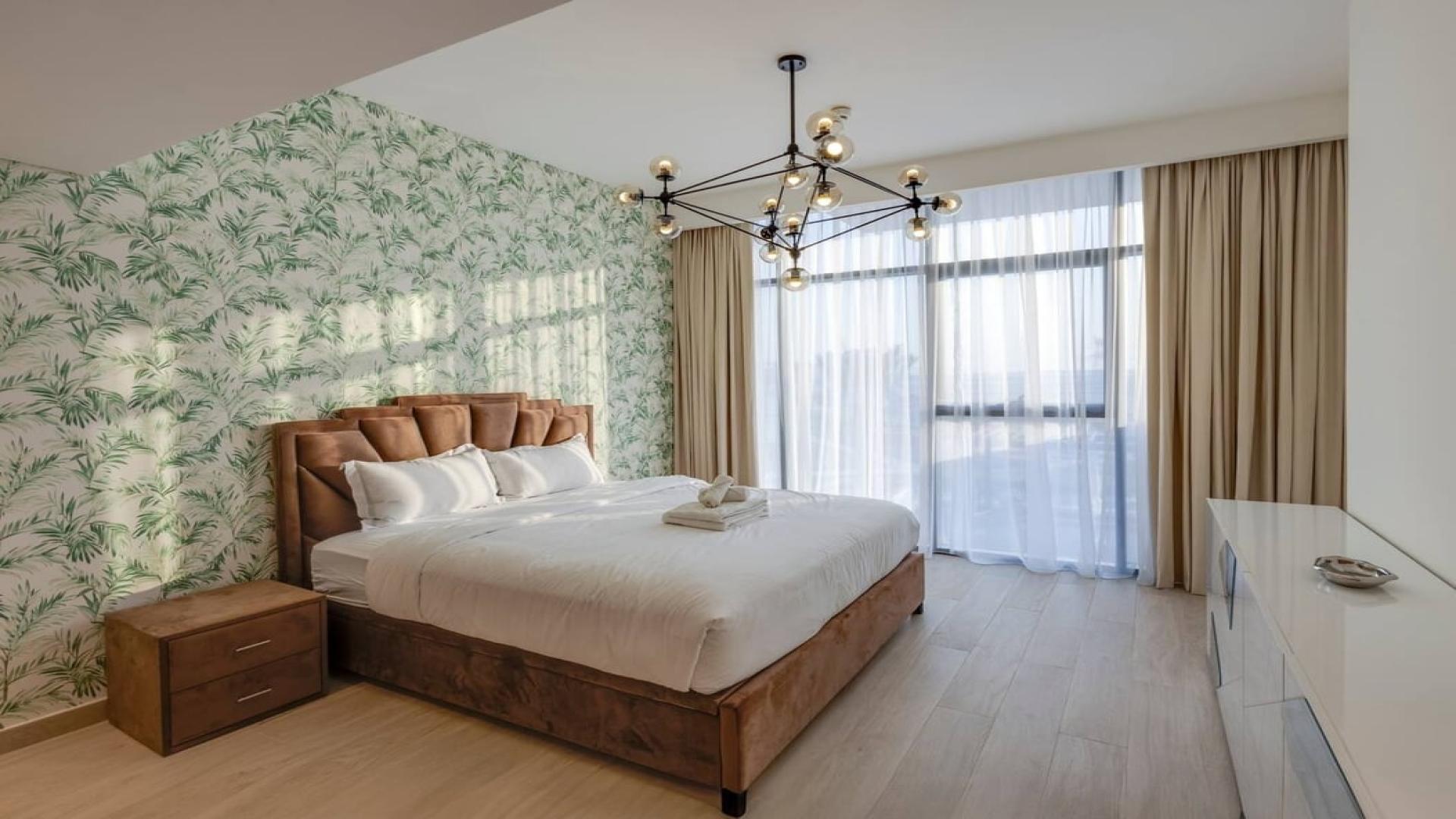 Dining area with blue chairs in stylish Meydan One apartment, LP43996