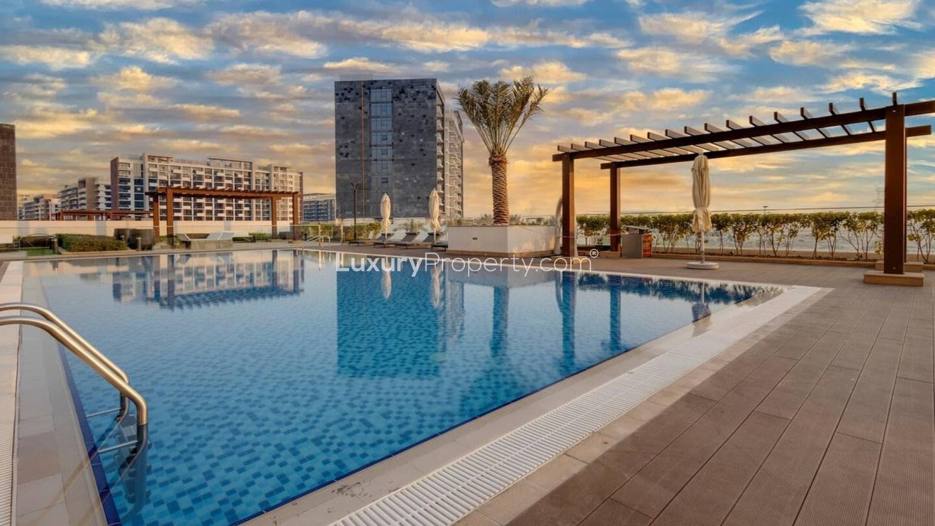 Bedroom view of Meydan One apartment with pool and landscape in Meydan