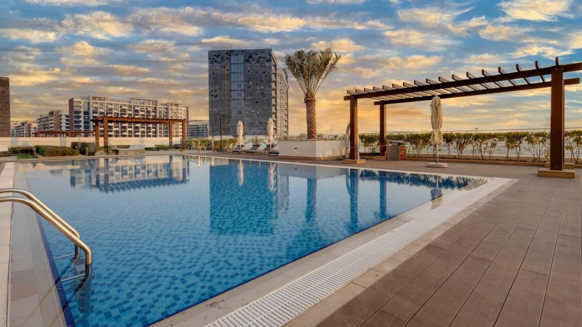 Bedroom view of Meydan One apartment with pool and landscape in Meydan