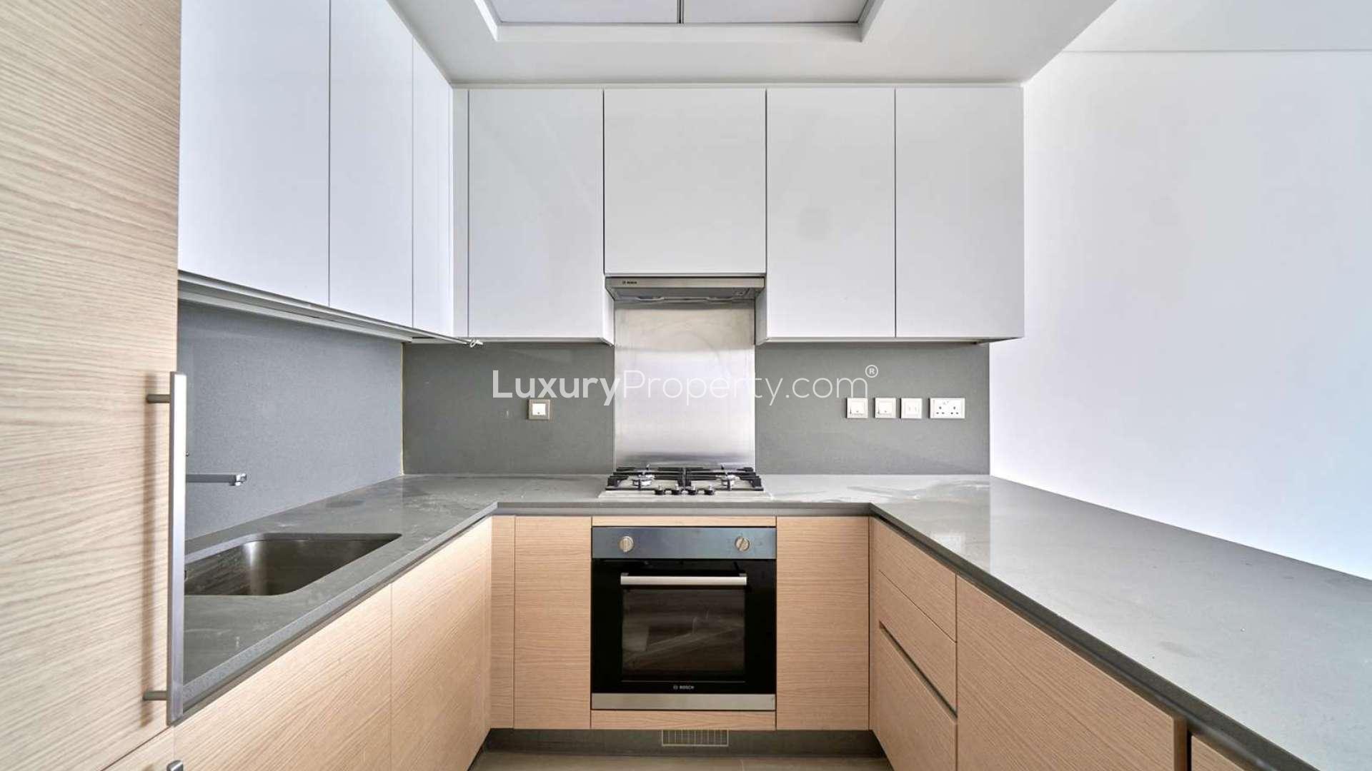 "Spacious apartment interior with sea view, large windows, in Palm Jumeirah, for sale.",Modern kitchen in Palm Jumeirah apartment, sleek countertops and built-in oven
