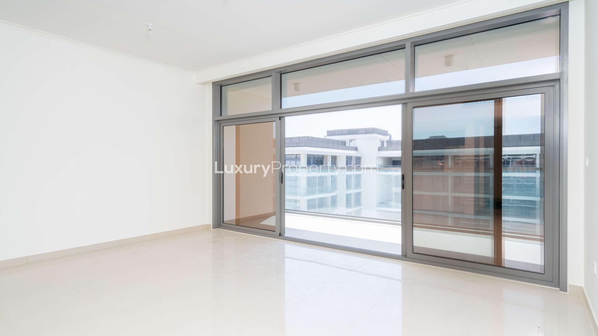 "Balcony view of pool and park at Mulberry Park Heights, Dubai Hills Estate apartment.","Bright living room with large windows in Dubai Hills Estate apartment for sale.",Empty living room with large windows in Mulberry Park Heights apartment, Dubai Hills Estate