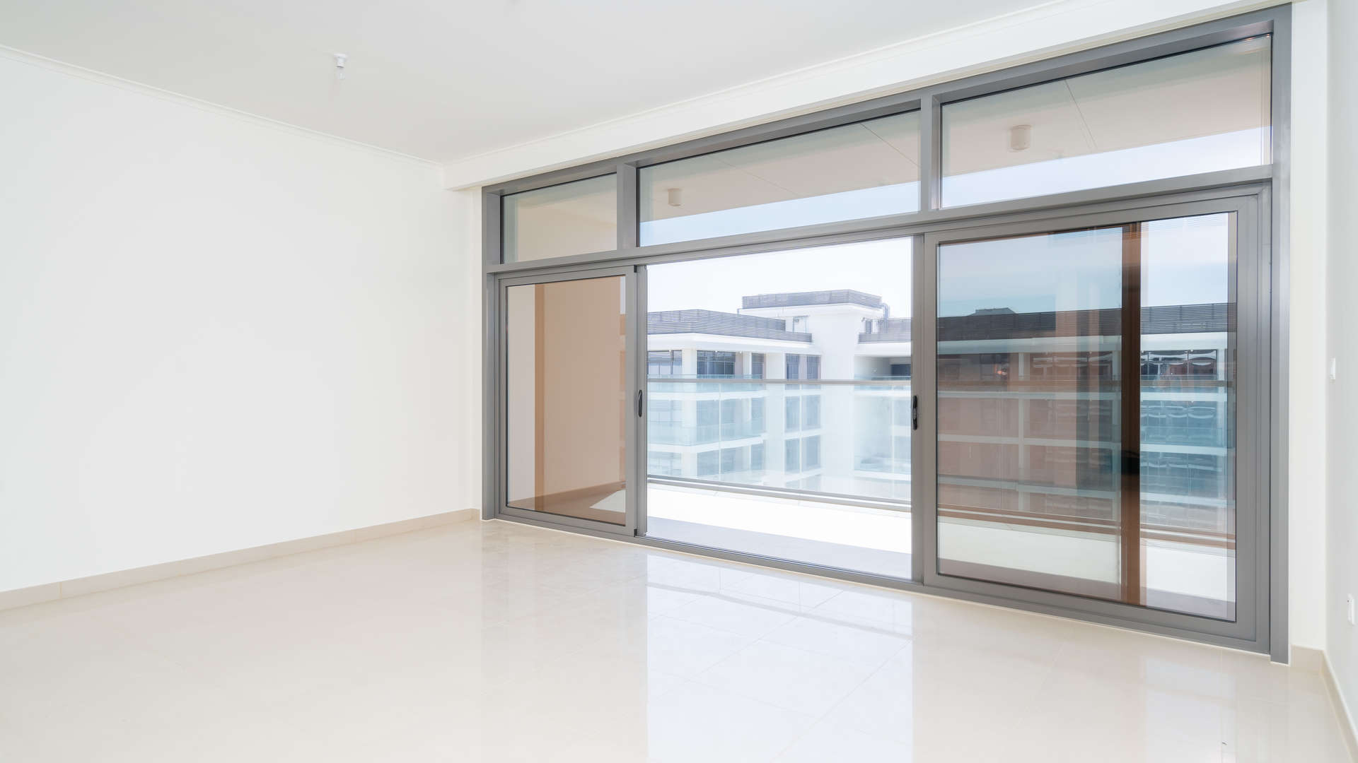 "Balcony view of pool and park at Mulberry Park Heights, Dubai Hills Estate apartment.","Bright living room with large windows in Dubai Hills Estate apartment for sale.",Empty living room with large windows in Mulberry Park Heights apartment, Dubai Hills Estate