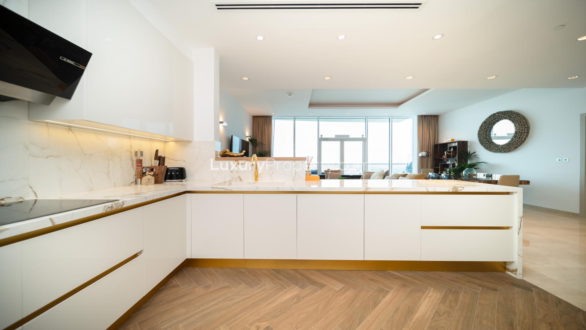 Modern open-plan kitchen and living area in Palm Jumeirah apartment for sale