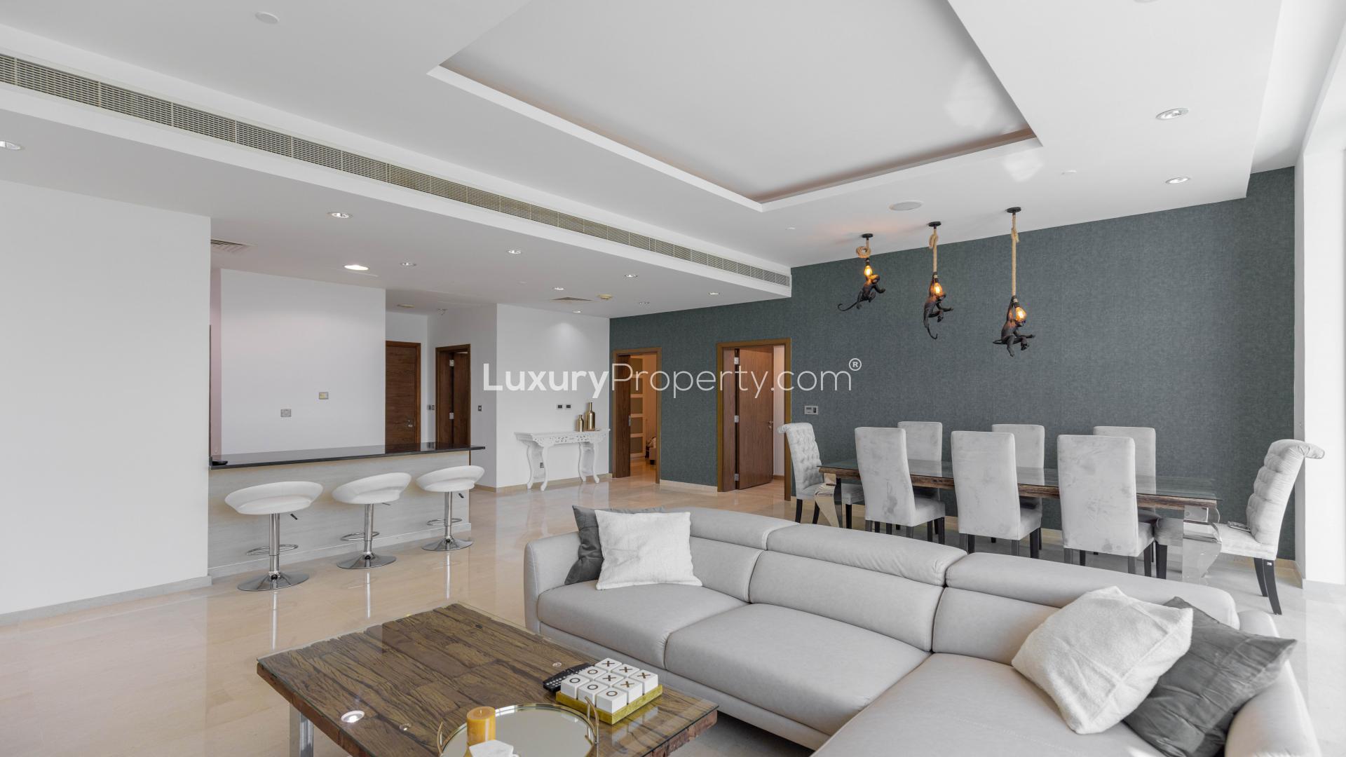 Modern open-plan living room and kitchen with sea view in Palm Jumeirah apartment