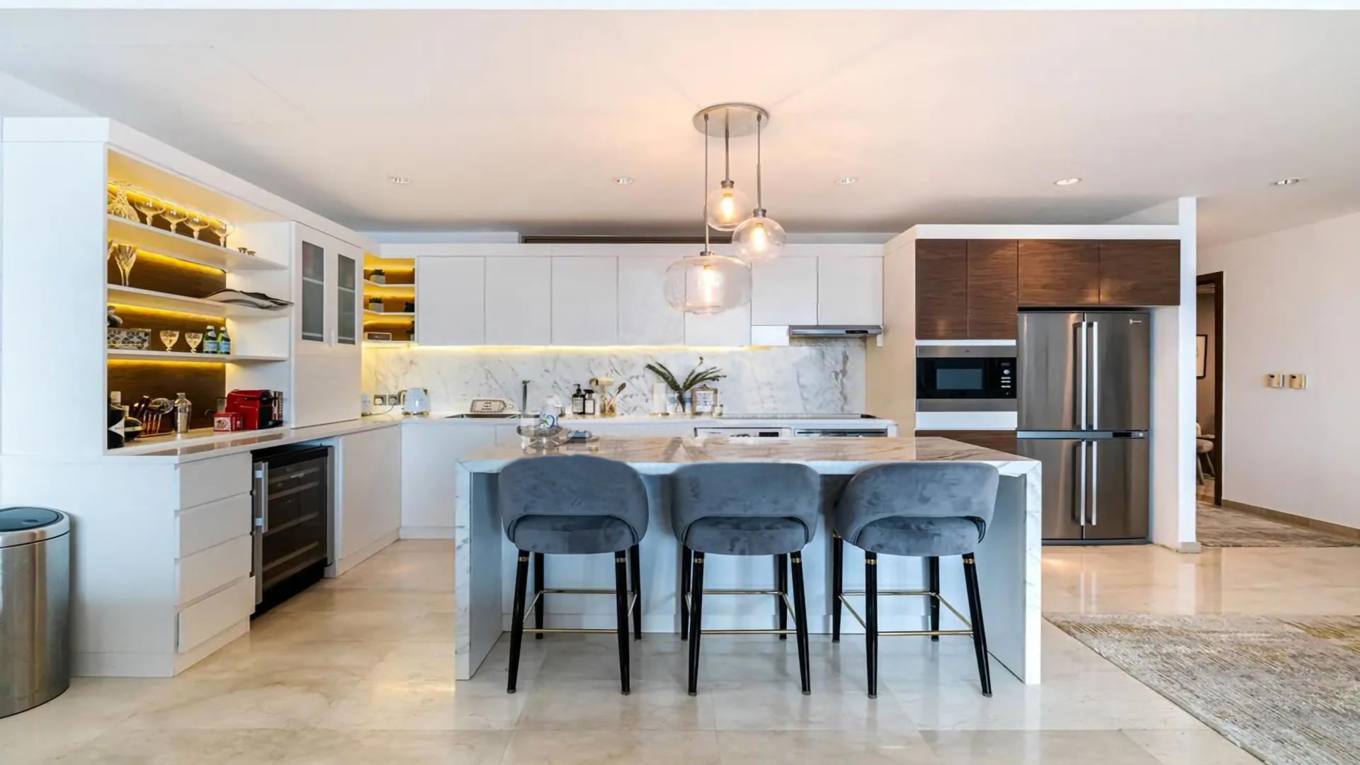 Luxurious living room in Palm Jumeirah apartment with modern decor and ample natural light