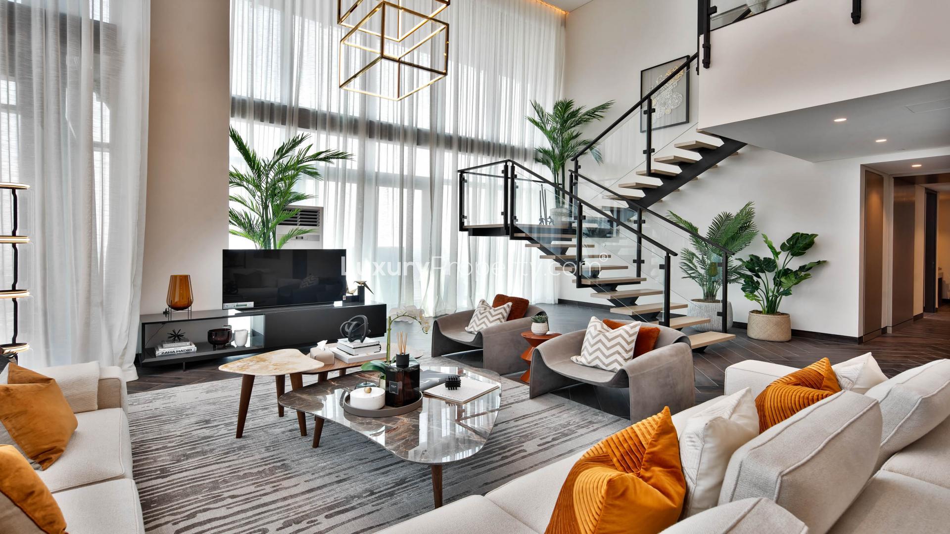 Modern living room in One Za'abeel duplex apartment, featuring stylish decor and open staircase