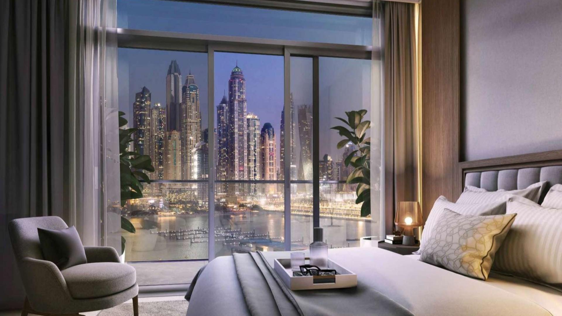 "Luxury Dubai Harbour apartment balcony with stunning city skyline and waterfront views at night.","Luxury Emaar Beachfront apartment bedroom with stunning Dubai Harbour skyline views at night.",Luxury Emaar Beachfront apartment dining room with sea view, Dubai Harbour