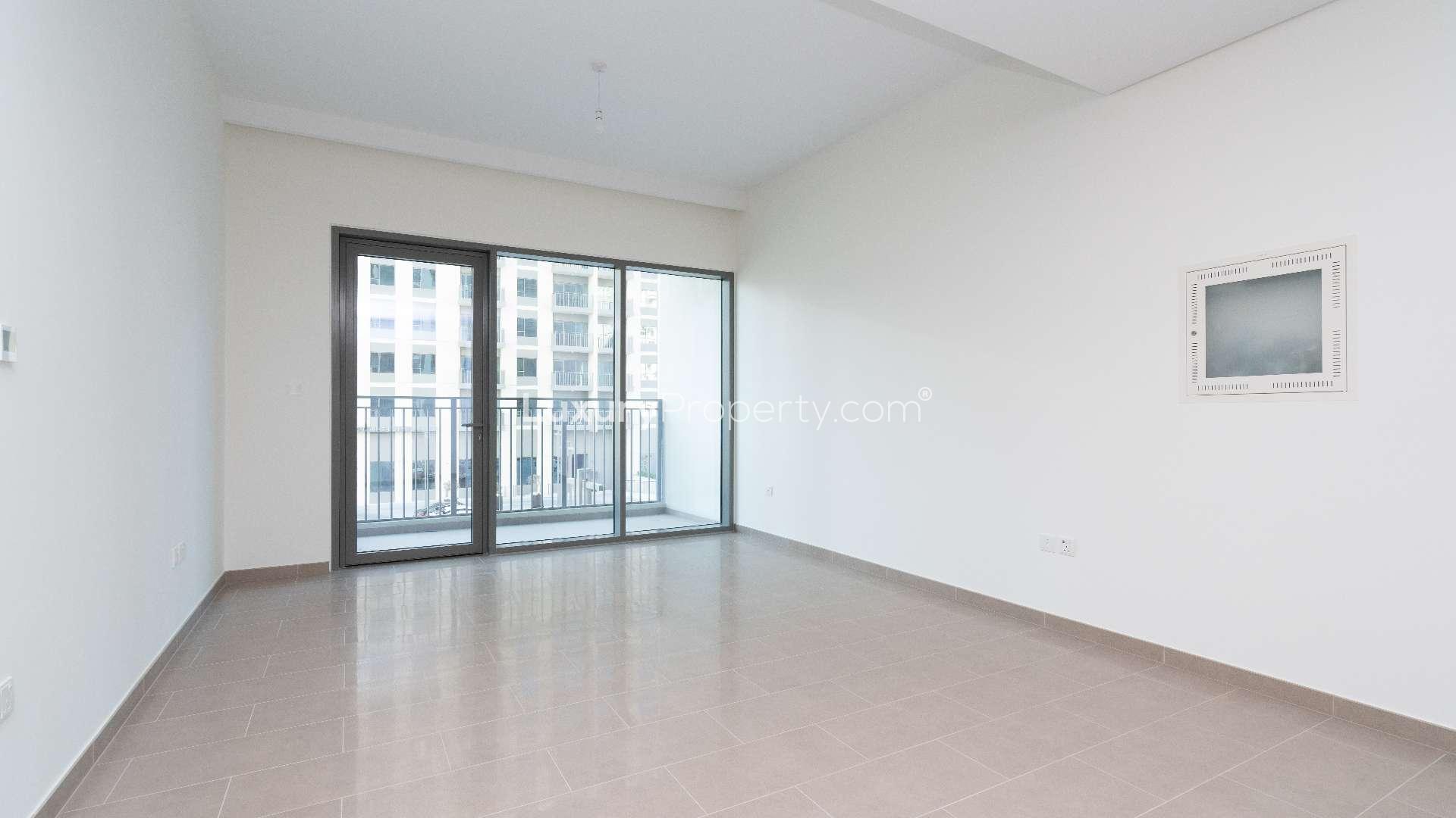 Balcony view of Dubai Hills Estate apartment for rent, overlooking parking area and buildings