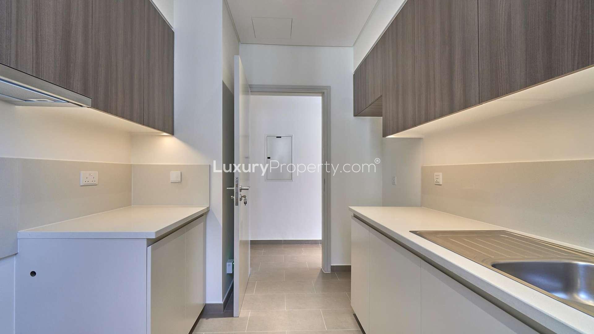 Modern kitchen in 2-bedroom apartment, Park Heights II, Dubai Hills Estate, featuring sleek cabinetry