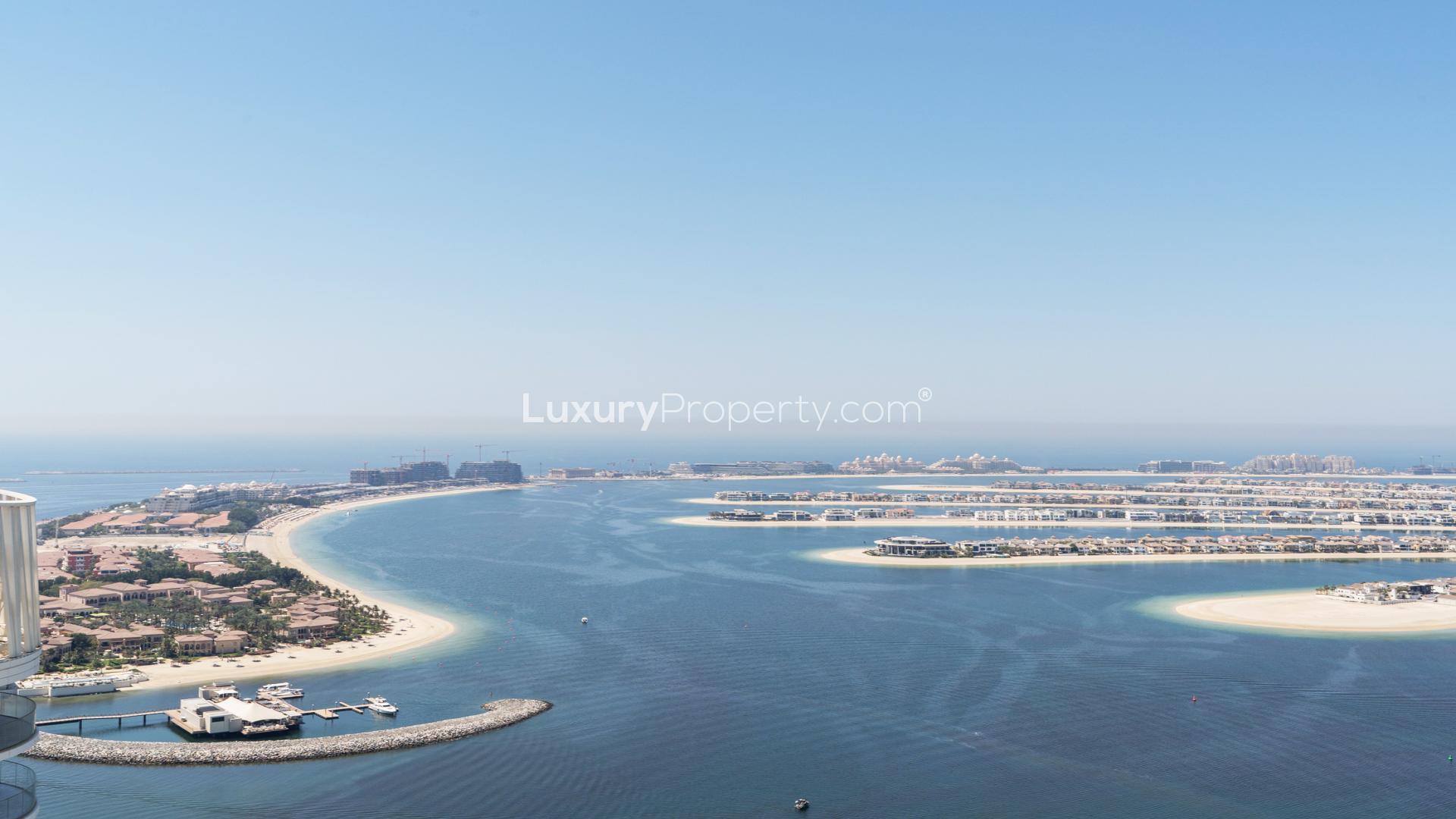 "Spacious balcony with stunning sea views at Emaar Beachfront, Dubai Harbour apartment for sale.",Aerial view of Emaar Beachfront, Dubai Harbour, near luxury waterfront apartment for sale