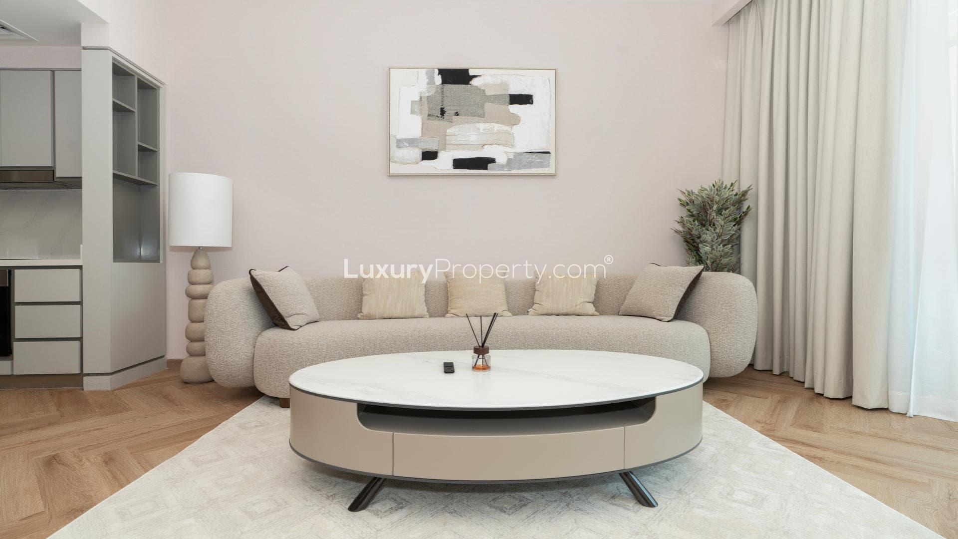 Modern living room in Dubai Harbour apartment with marina skyline view through balcony