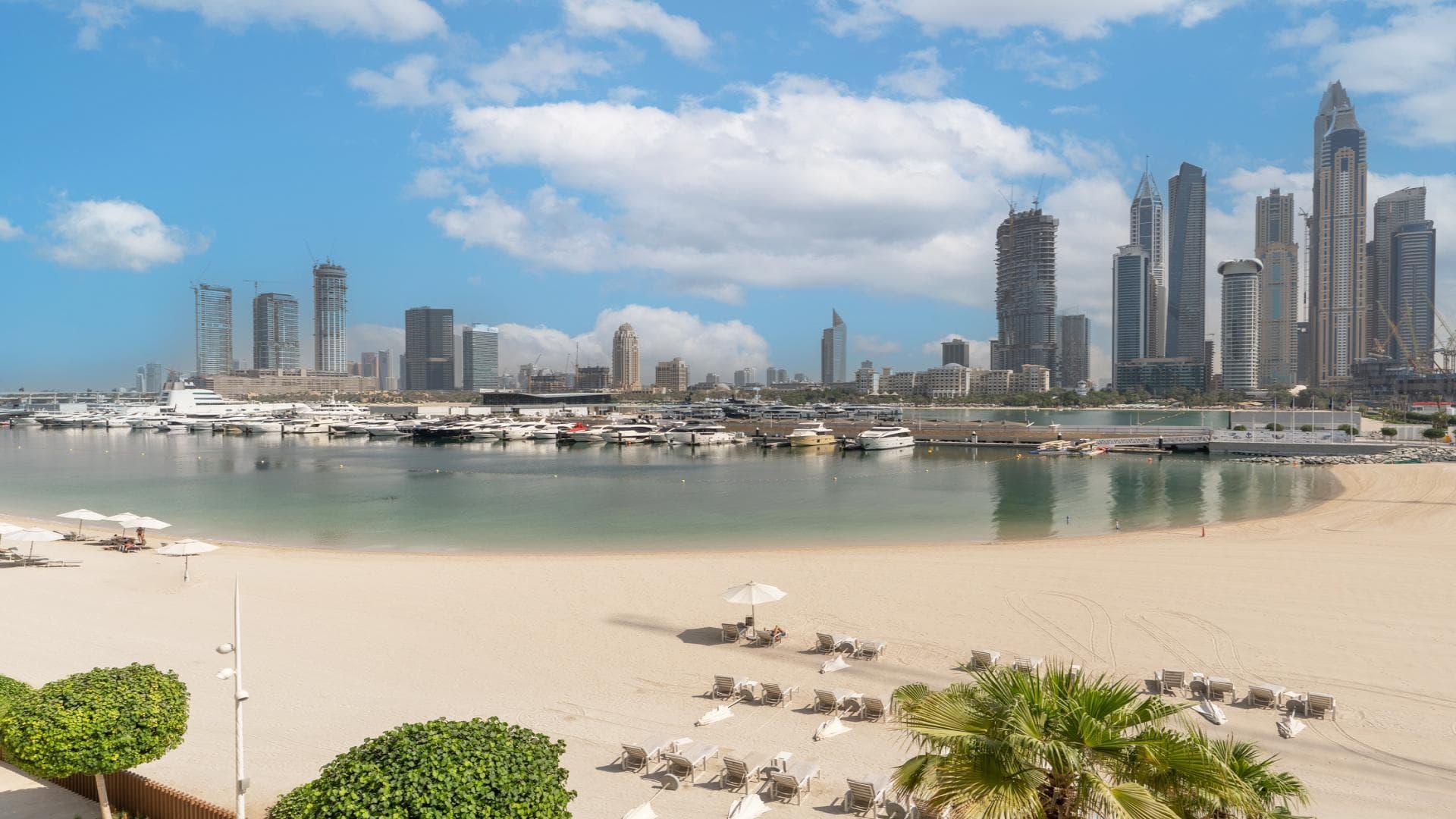 "Balcony view of Dubai Harbour beach and marina skyline from Emaar Beachfront apartment.",Beachfront view from two-bedroom apartment in Emaar Beachfront, Dubai Harbour, overlooking marina skyline