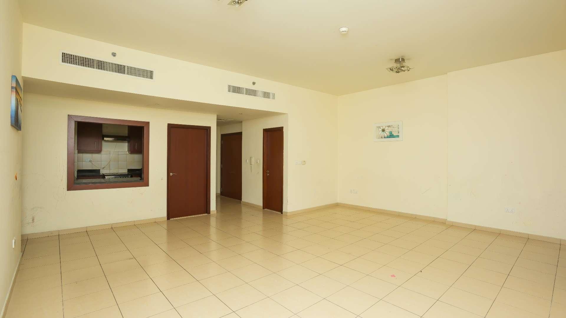 Empty bedroom with wooden closet in Rimal 1 apartment, Jumeirah Beach Residence