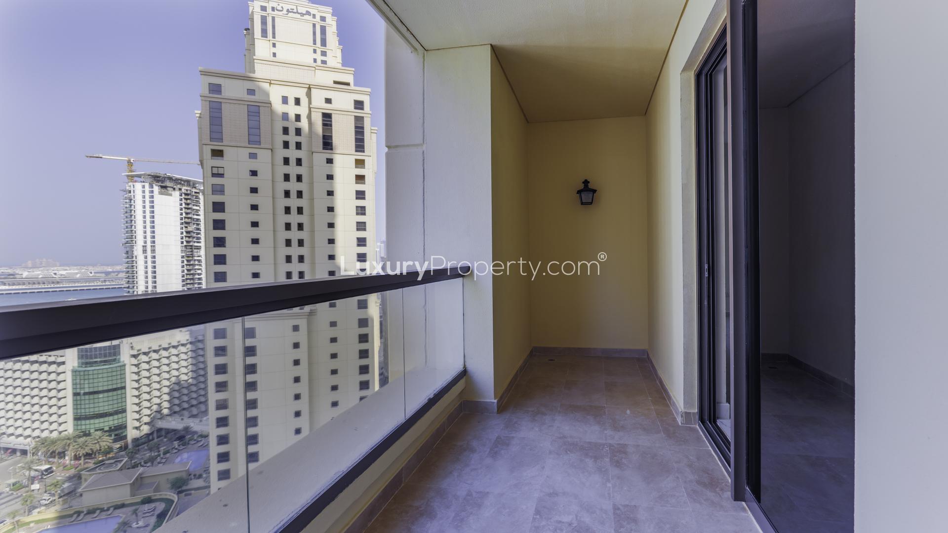 "Balcony view from Rimal 1 apartment in Jumeirah Beach Residence, Dubai skyline visible.",Newly upgraded kitchen in 2-bedroom apartment, Rimal 1, Jumeirah Beach Residence