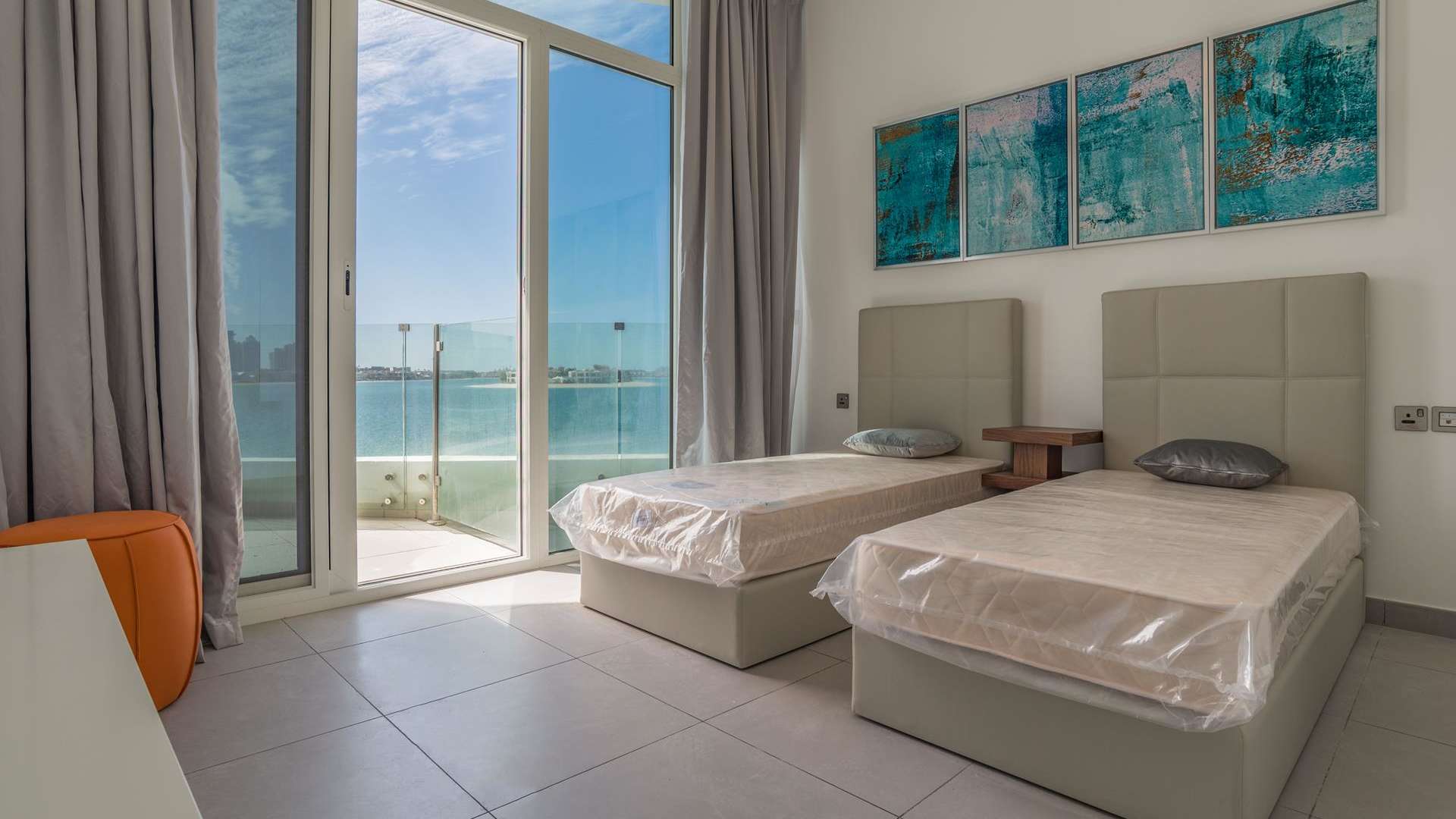 Bright bedroom with twin beds, balcony, and sea view in Royal Bay, Palm Jumeirah apartment