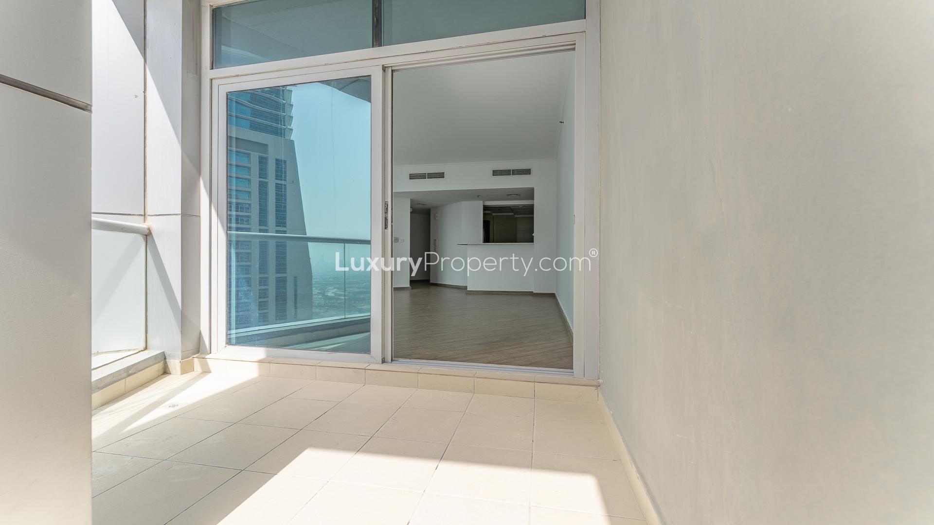 "Spacious balcony view of vacant 2-bedroom apartment in Torch Tower, Dubai Marina.",Vacant upgraded 2-bedroom apartment interior with wooden flooring in Torch Tower, Dubai Marina