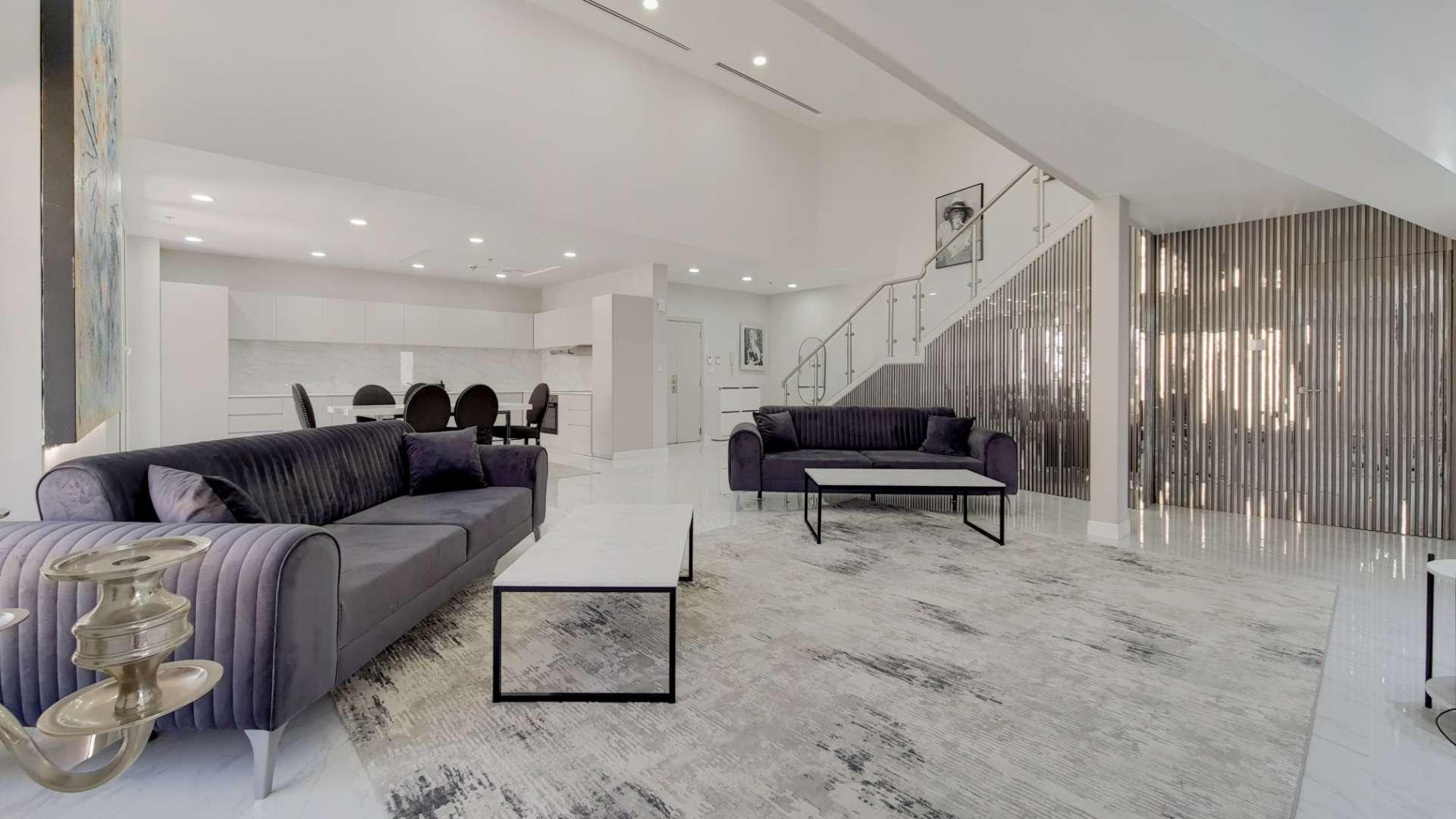 High-floor Jumeirah Beach Residence loft interior with modern decor and large artwork