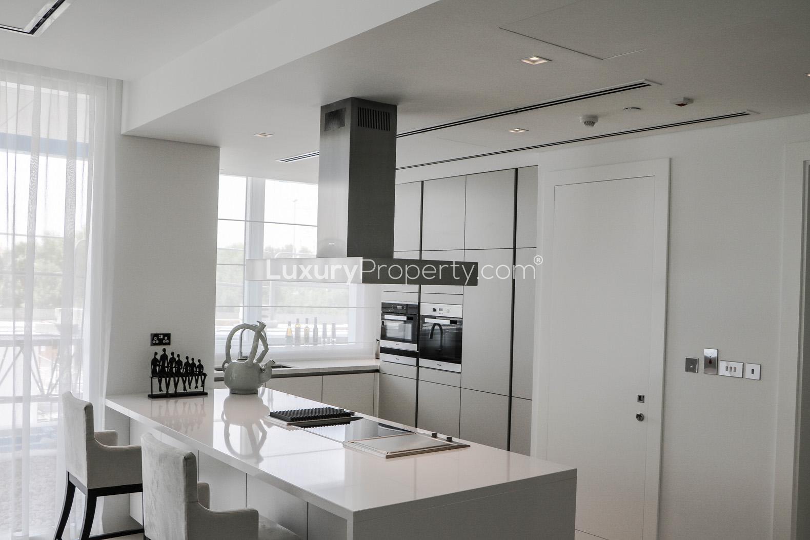 Stunning living room in Seventh Heaven apartment, Al Barari, with modern decor and elegant chandelier