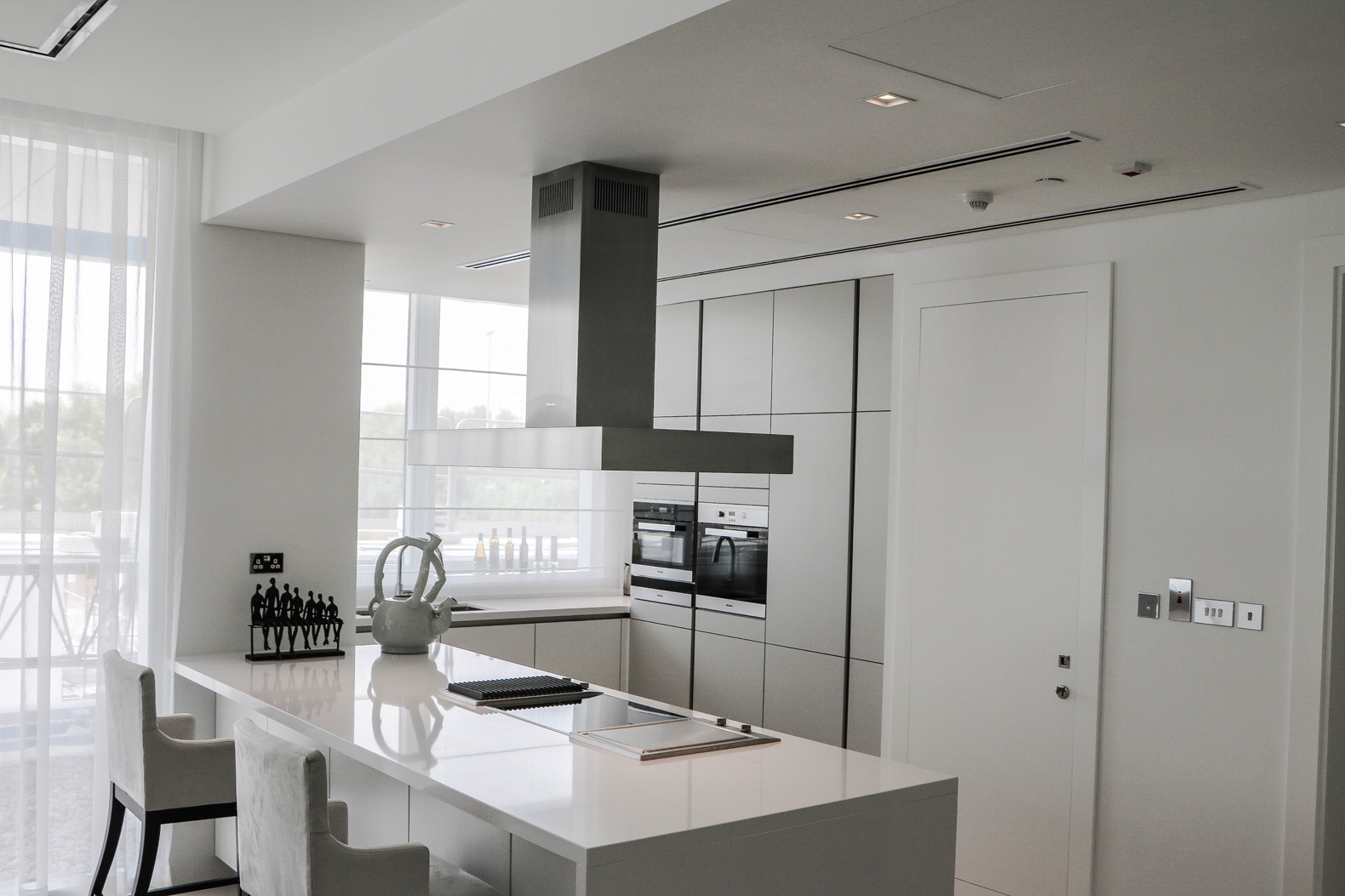 Stunning living room in Seventh Heaven apartment, Al Barari, with modern decor and elegant chandelier