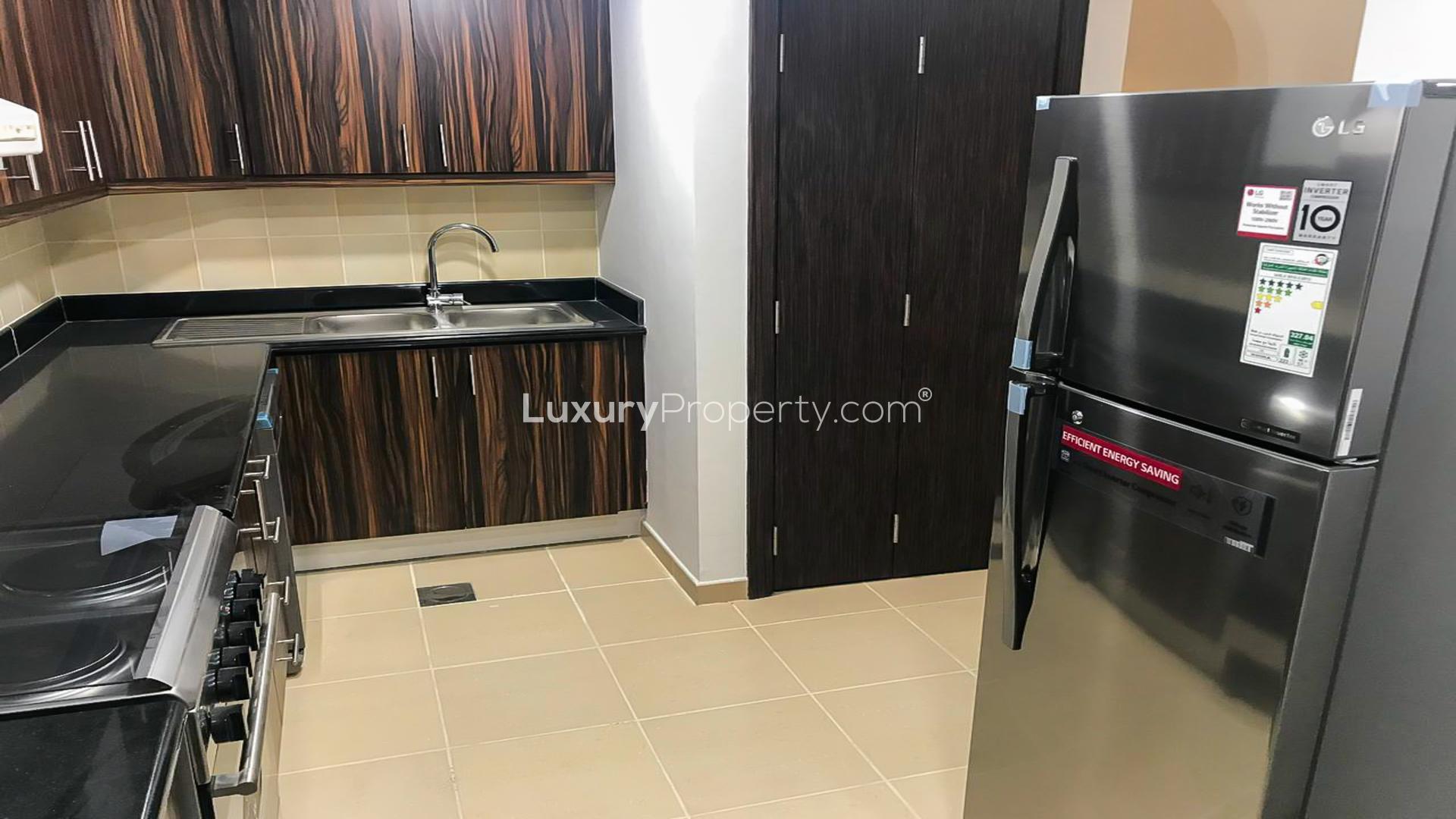"Modern living room in semi-upgraded JBR apartment, sea views through large windows.",Modern kitchen in semi-upgraded JBR apartment, featuring sleek cabinets and stainless steel appliances