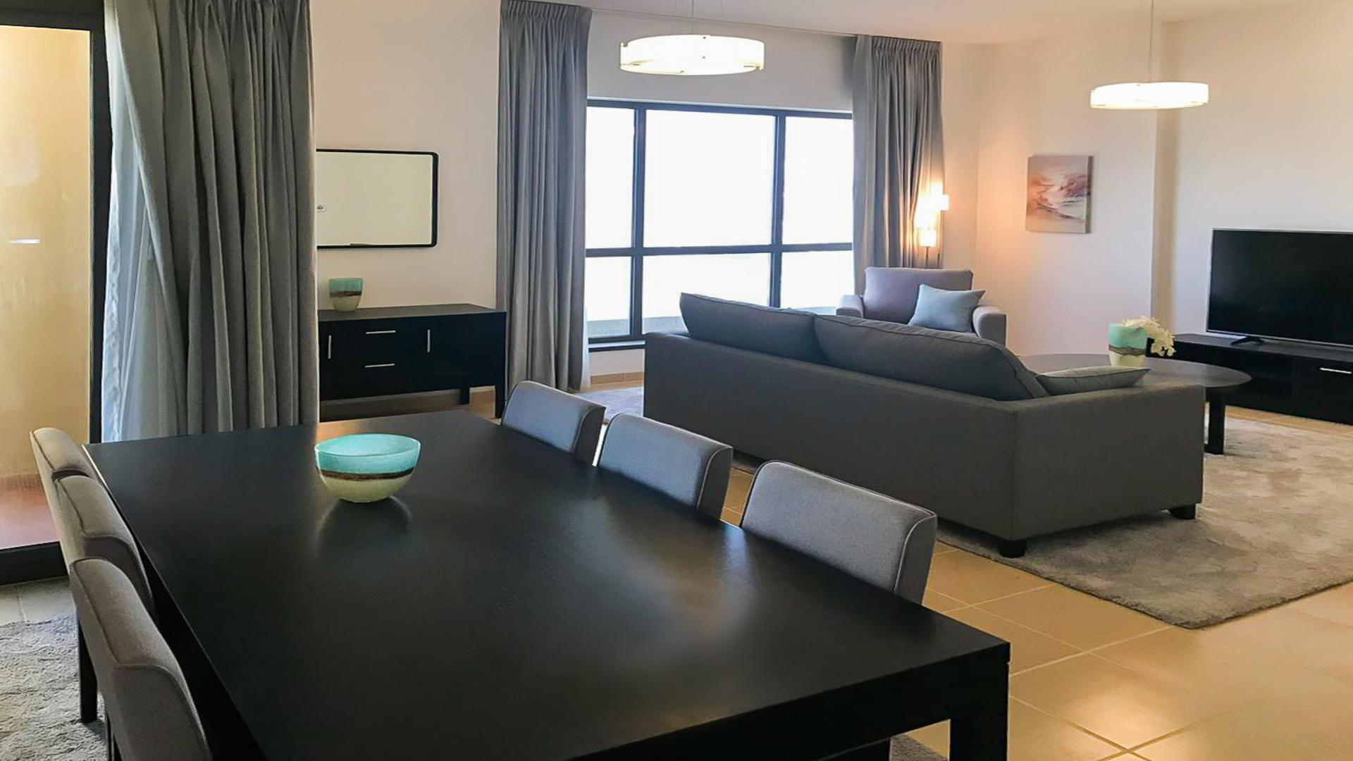 Modern living room in semi-upgraded JBR apartment, Shams, featuring comfortable seating and decor