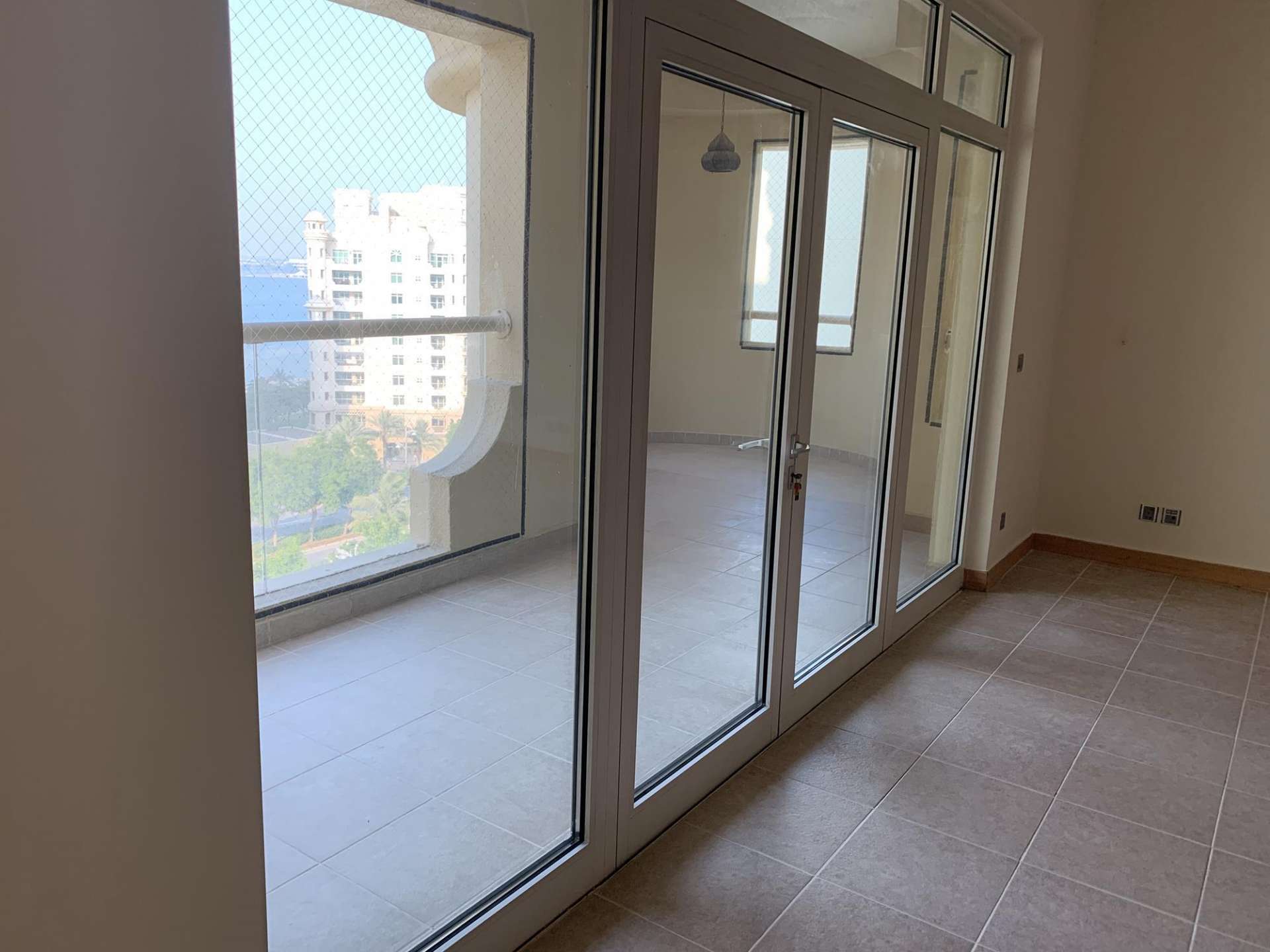 Spacious living room with large windows in Al Shahla apartment, Palm Jumeirah