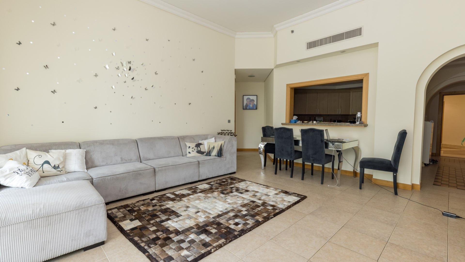 Balcony view from Shoreline Apartment in Palm Jumeirah, surrounded by lush greenery