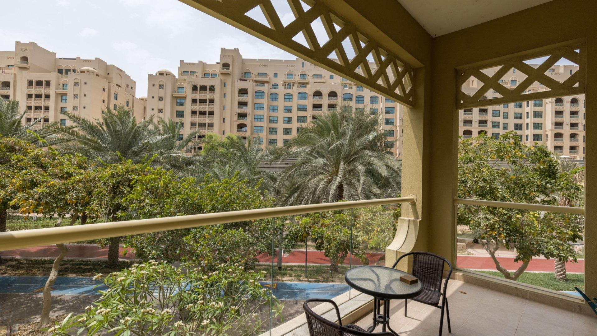 Modern living room in Palm Jumeirah apartment with balcony view, Shoreline Apartments