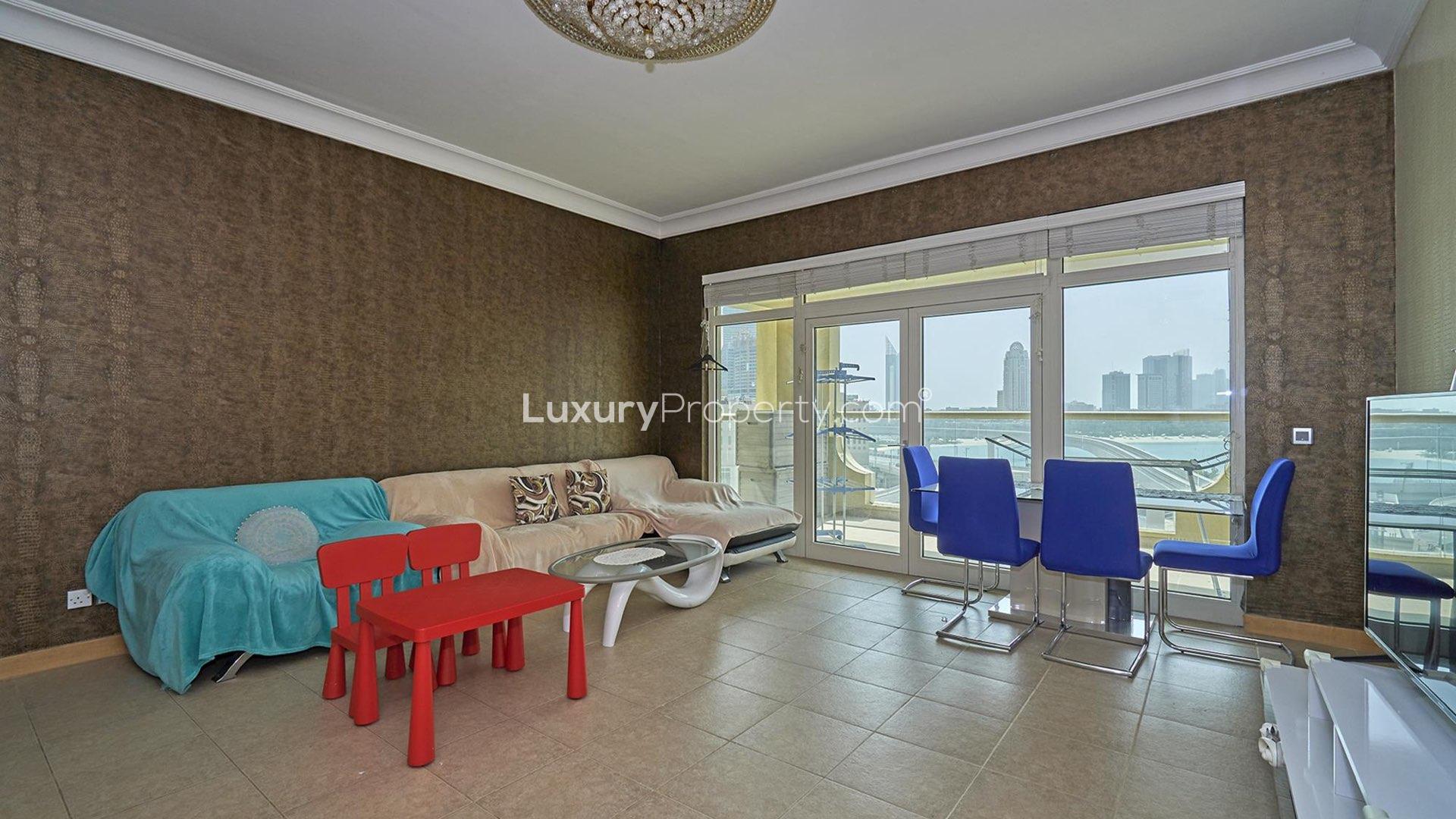 Exterior view of Shoreline Apartments in Palm Jumeirah, featuring tall palm trees