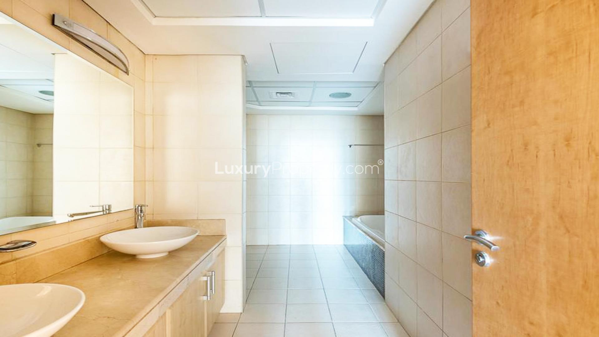 Spacious living room in Shoreline Apartment, Palm Jumeirah, with large windows and balcony access