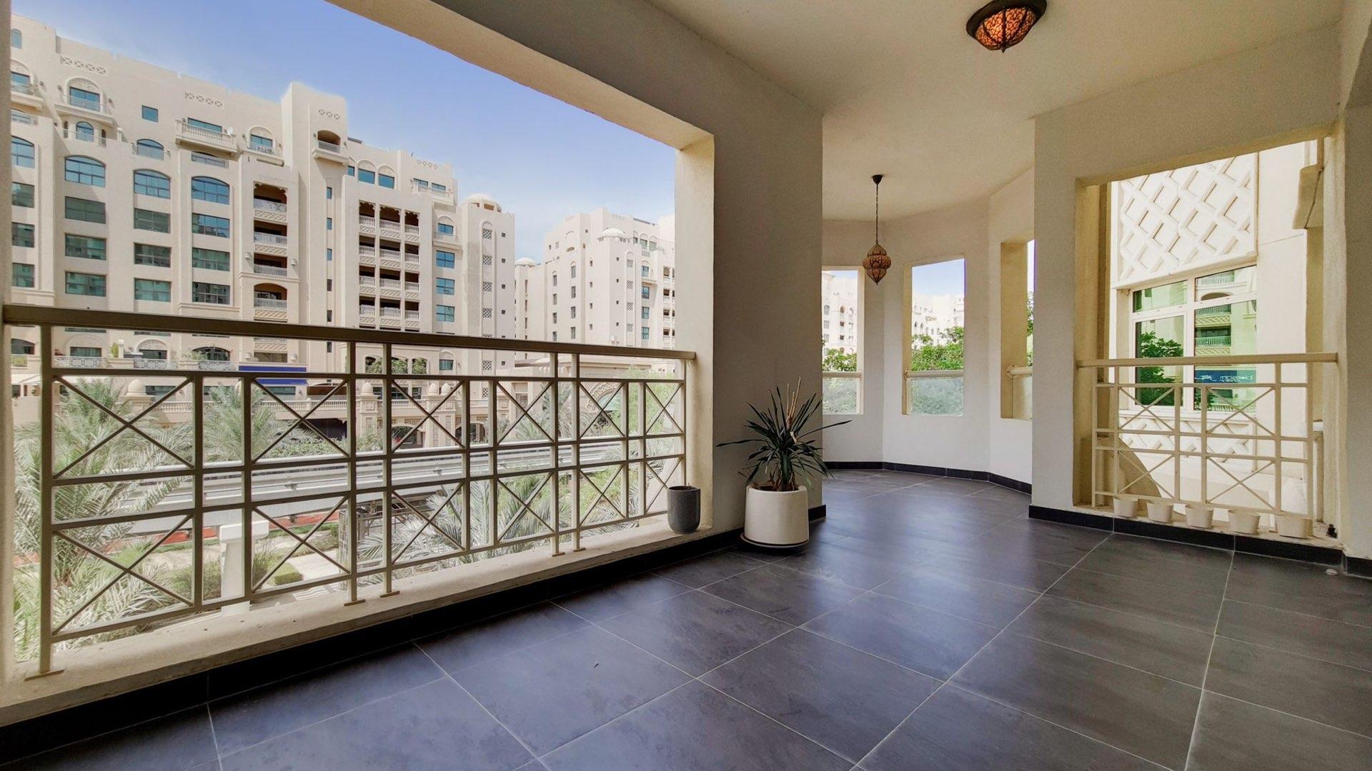 "Spacious living area in upgraded 2-bedroom apartment, Shoreline Apartments, Palm Jumeirah for sale.",Spacious balcony view from upgraded 2-bedroom apartment in Shoreline Apartments, Palm Jumeirah